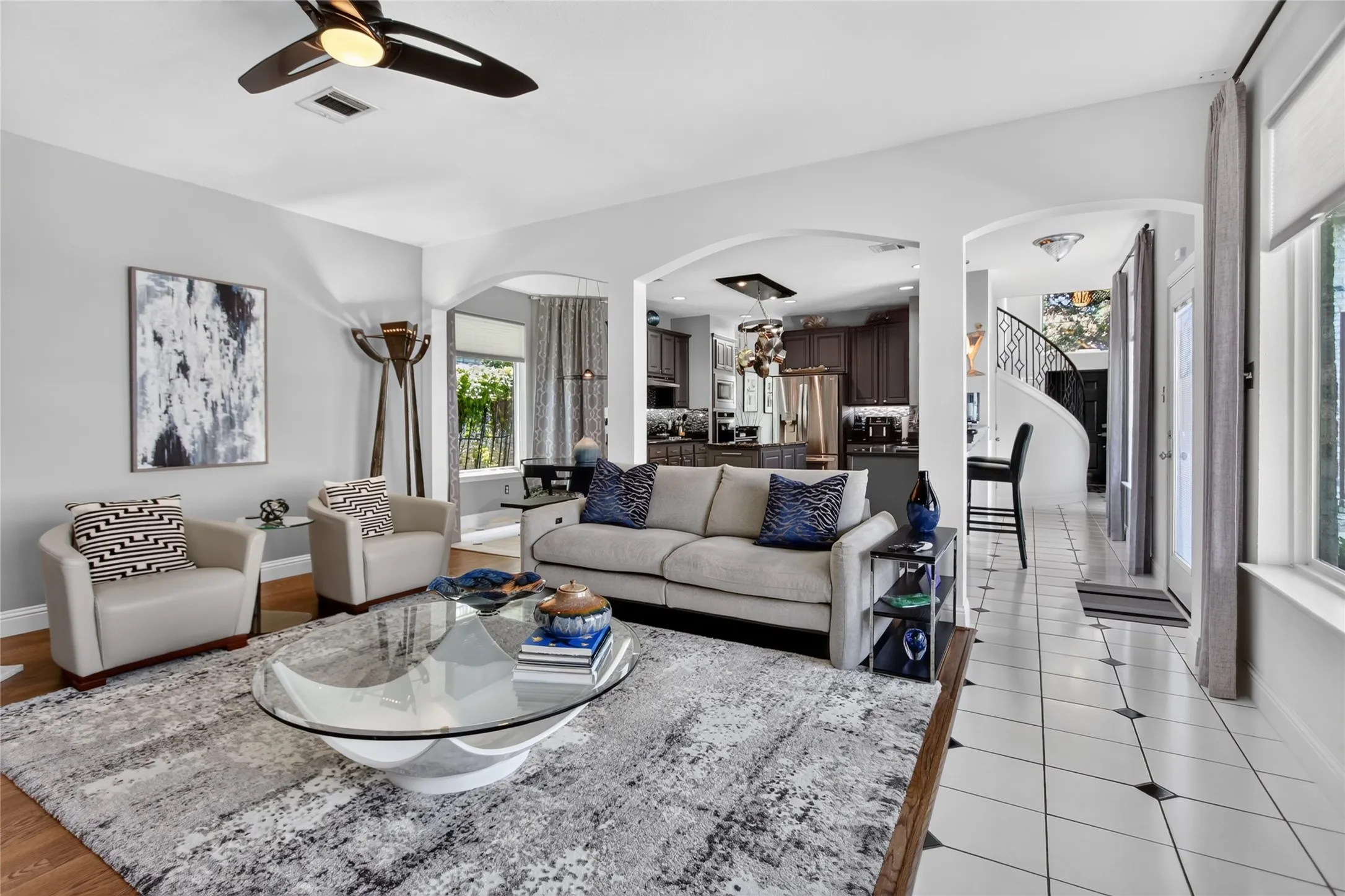 Open concept Kitchen and Living room. Light, bright and great space options for entertaining. Counter height area in kitchen allows for additional bar seating. Pattern tile walk way leads to the front of the home. Door off the kitchen opens to covered pergola and your pool & spa.