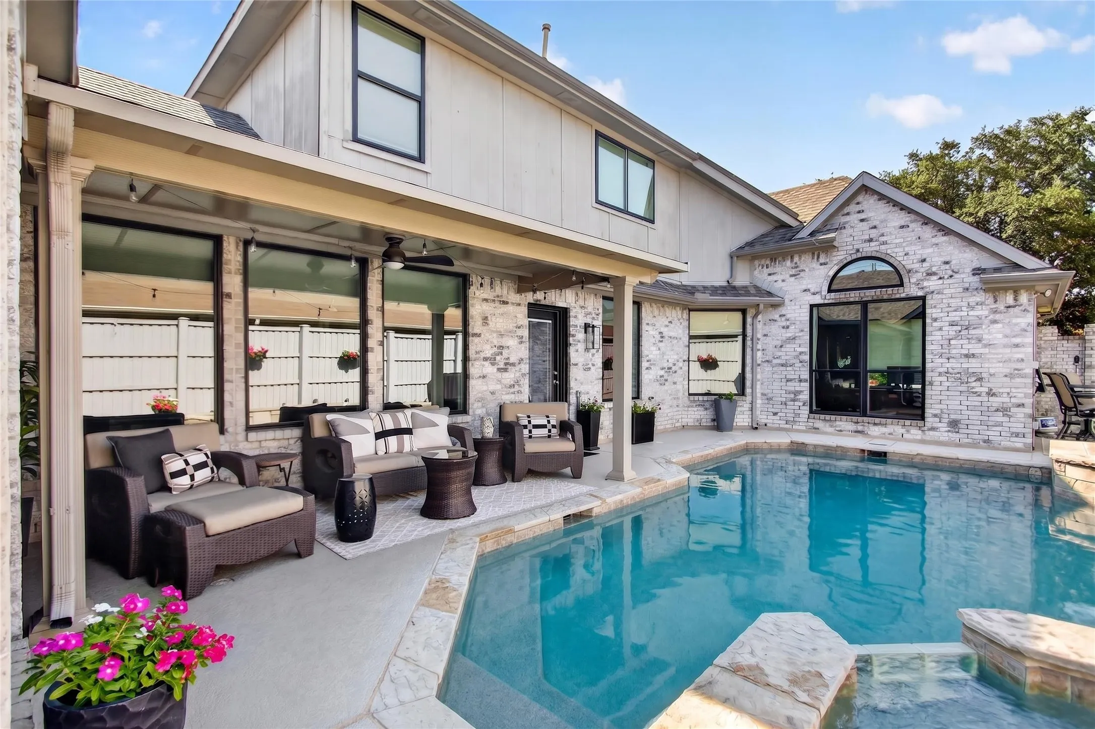 Step outside to a resort style backyard designed for both relaxation and entertaining. A spacious covered patio with fans and lights has ample space  for multiple seating arrangements