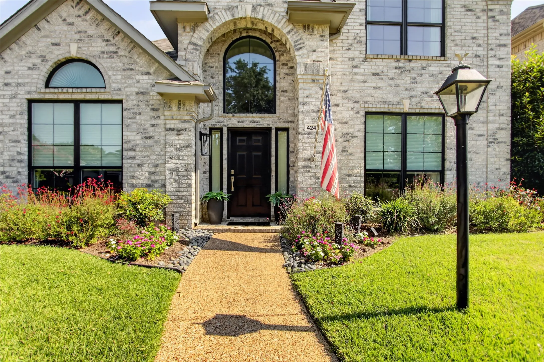 Exceptional Curb Appeal Meets Timeless StyleBeautifully maintained and thoughtfully designed, this south-facing two-story home makes a lasting first impression. The striking salt-and-pepper brick exterior is complemented by professionally landscaped grounds, creating elegant curb appeal year-round. A rear-entry garage keeps the front elevation clean and inviting, enhancing the home’s classic architectural charm.