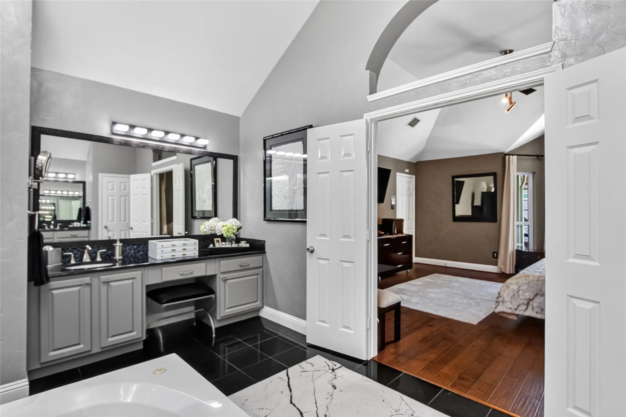 View of one of two vanities and entrance to primary suite. This primary bathroom maybe as large as the Primary bedroom.
