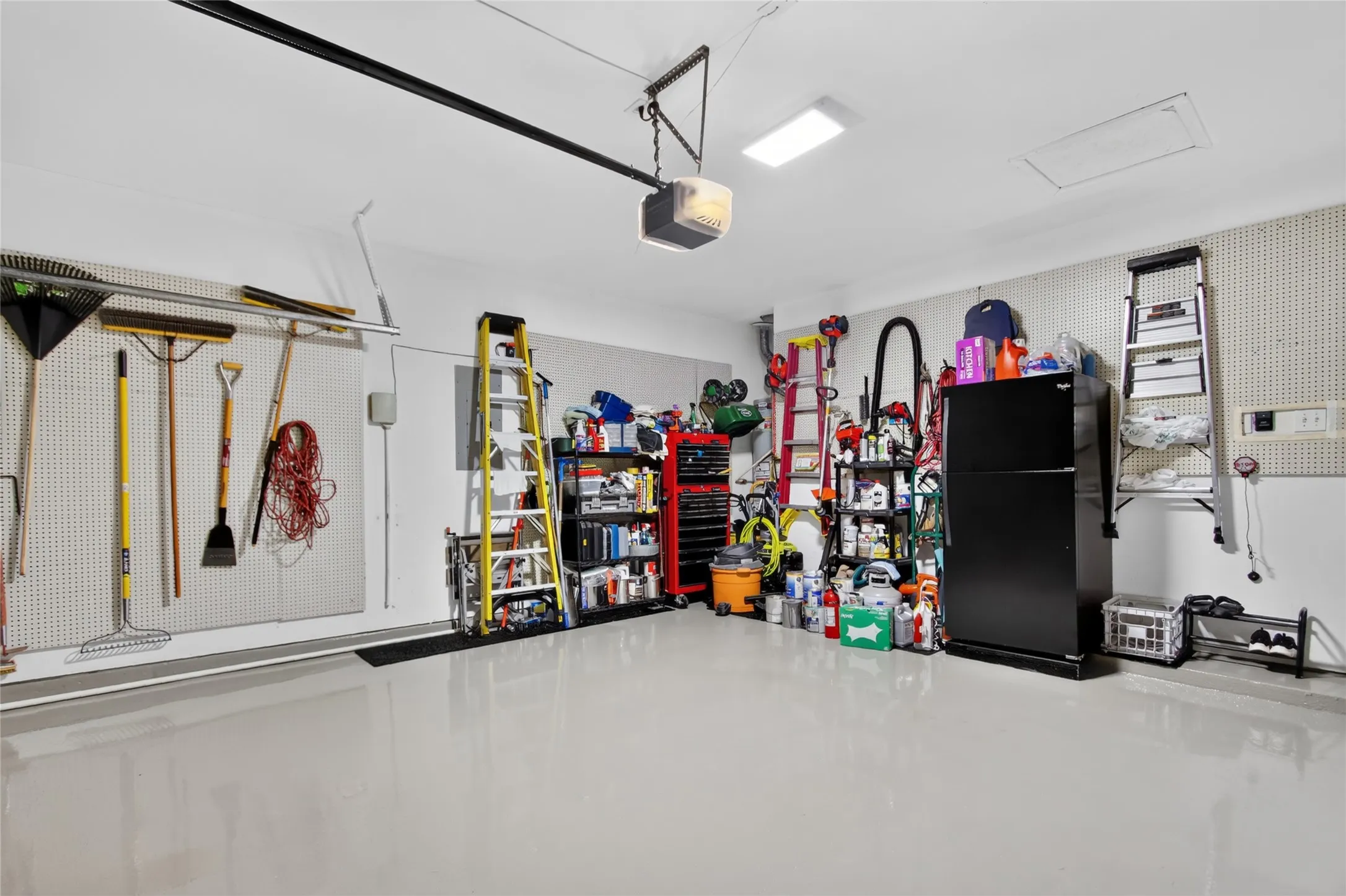 You could Eat off the Floor...seriously I want this garage. Epoxy floor redone in 2017, wall holders for all your tools and yard supplies. Plenty of space for everything and 2 Cars.  Garage is at the rear of the home. New gas water heater installed in 2026.  Very Impressive