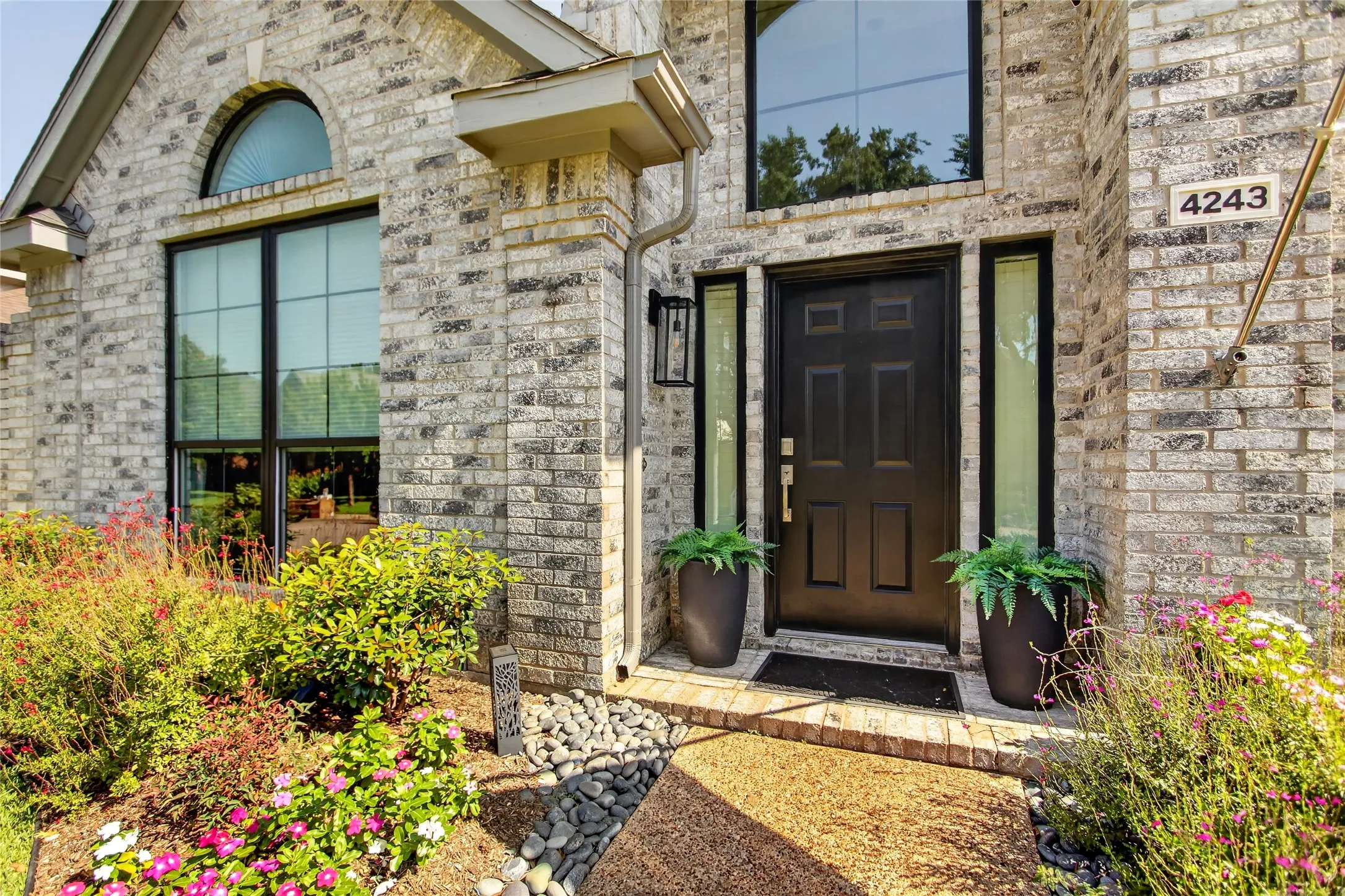 Beautifully maintained flower beds filled with seasonal color creating a picture perfect first impression.
