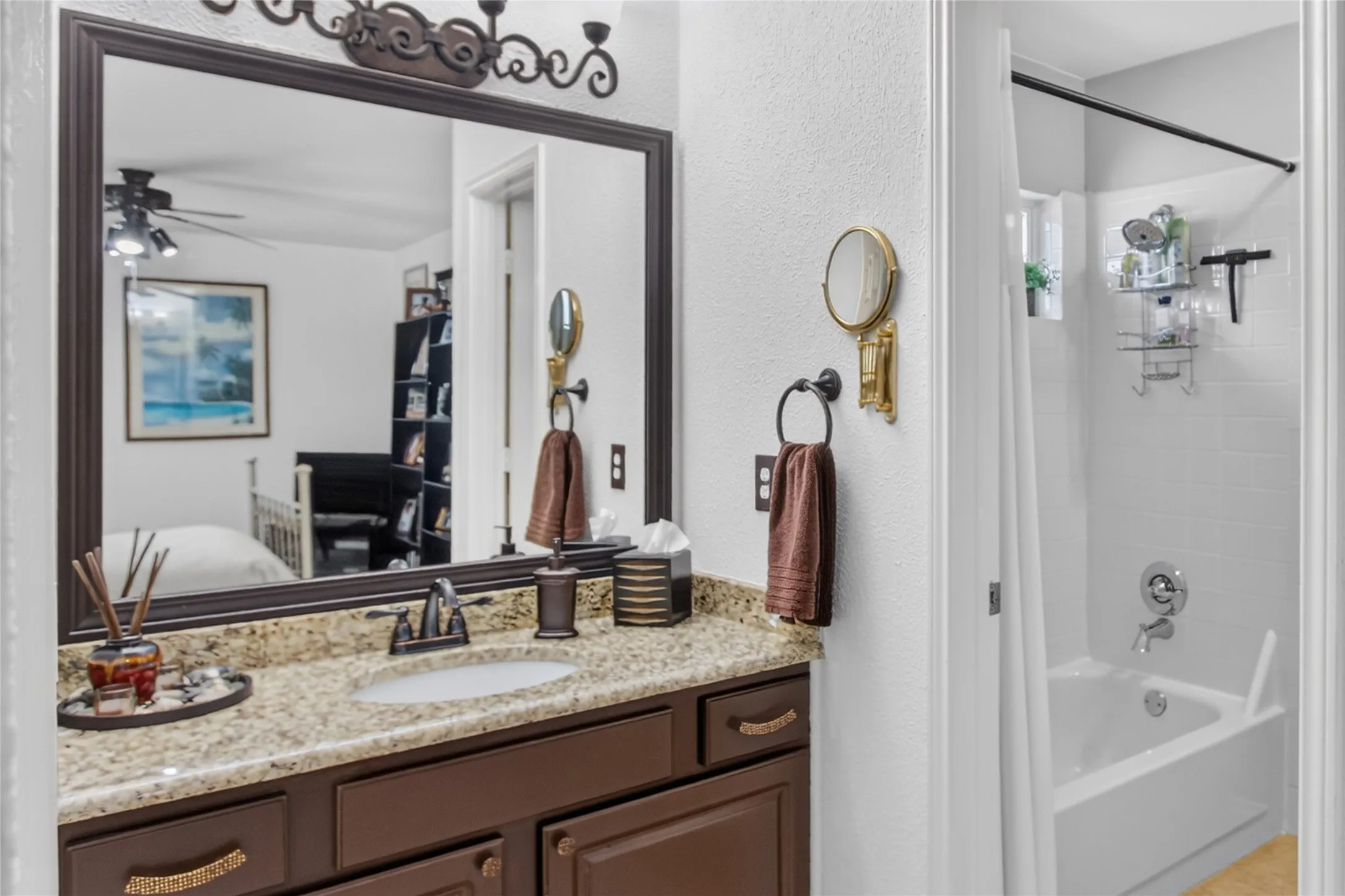 View of one of the two sink areas supporting the Jack N Jill bath up. Granite counter top, full size mirror, shower-tub combination. Identical vanity on opposite end of Jack N Jill bathroom.