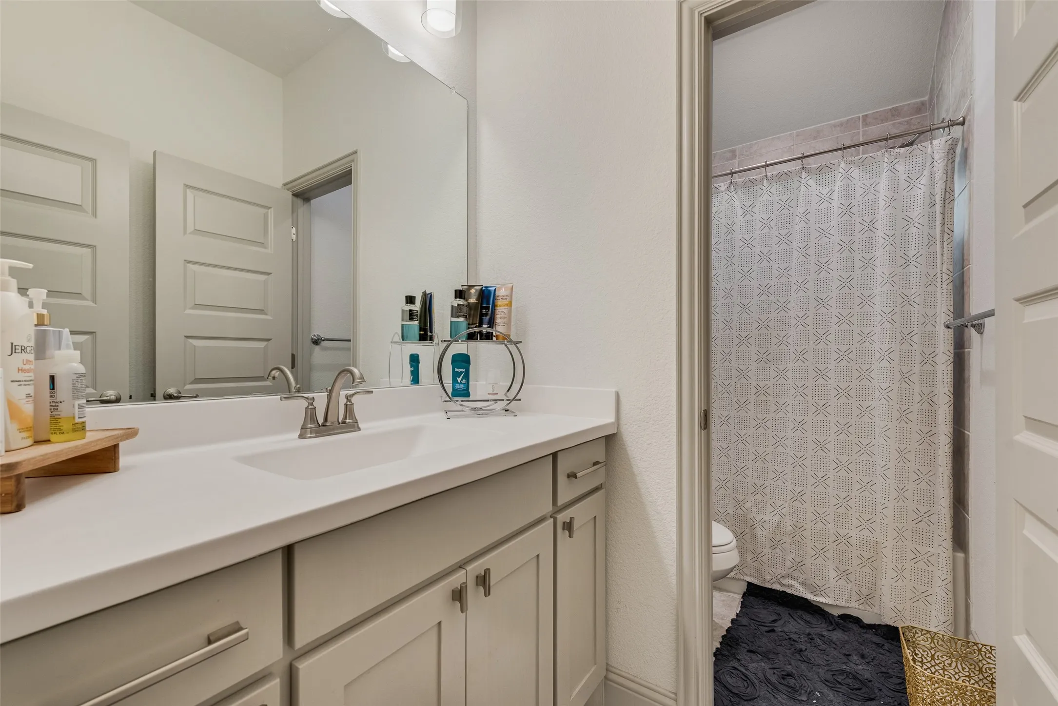Secondary full bathroom with vanity storage and a tub/shower combination