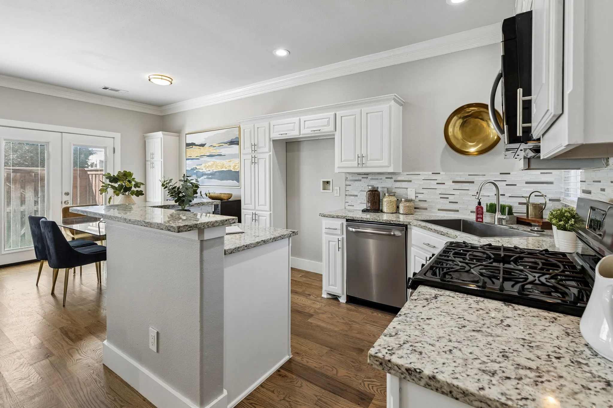White shaker cabinetry, and granite countertops