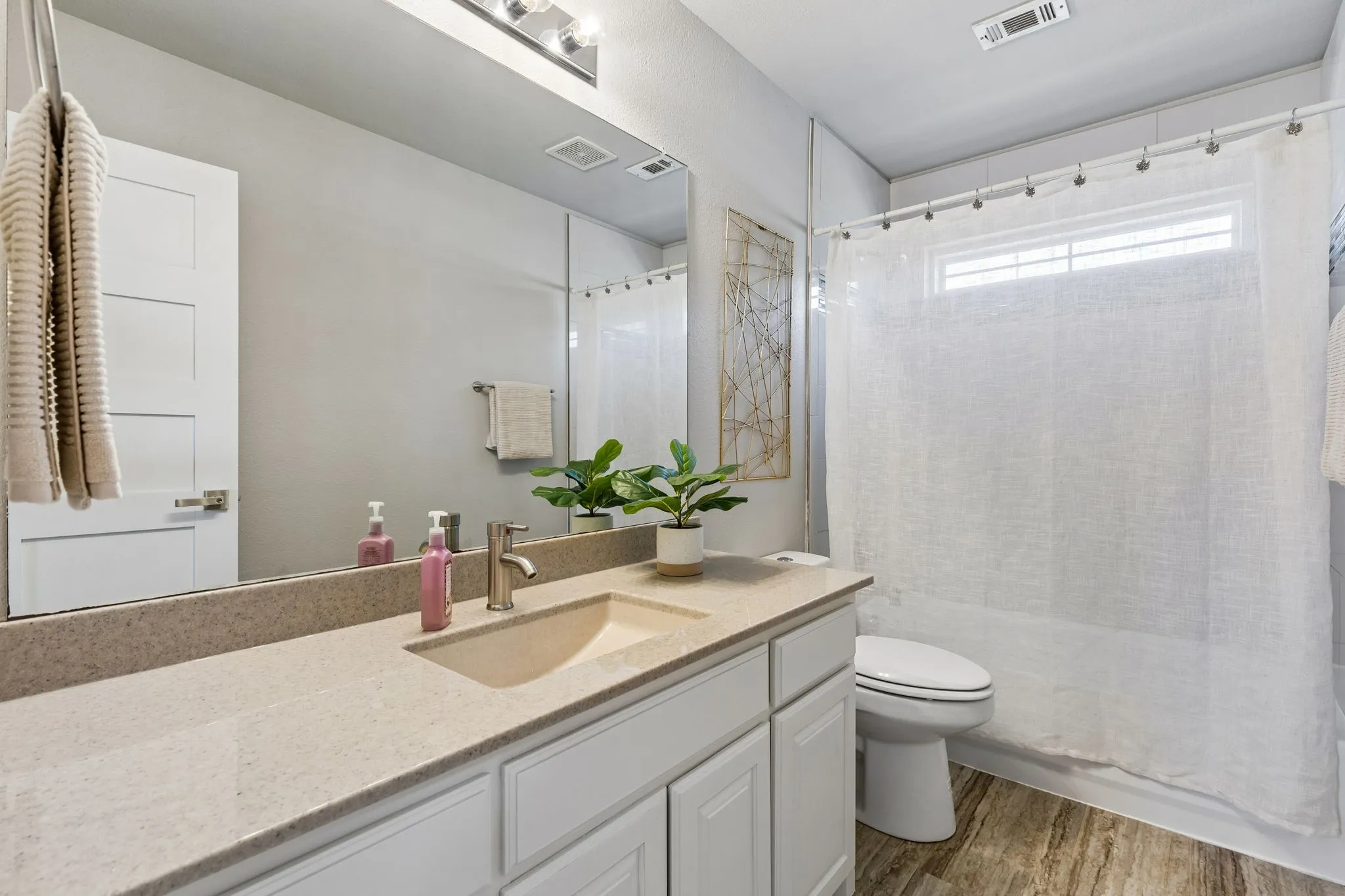 Shared bathroom with a tub