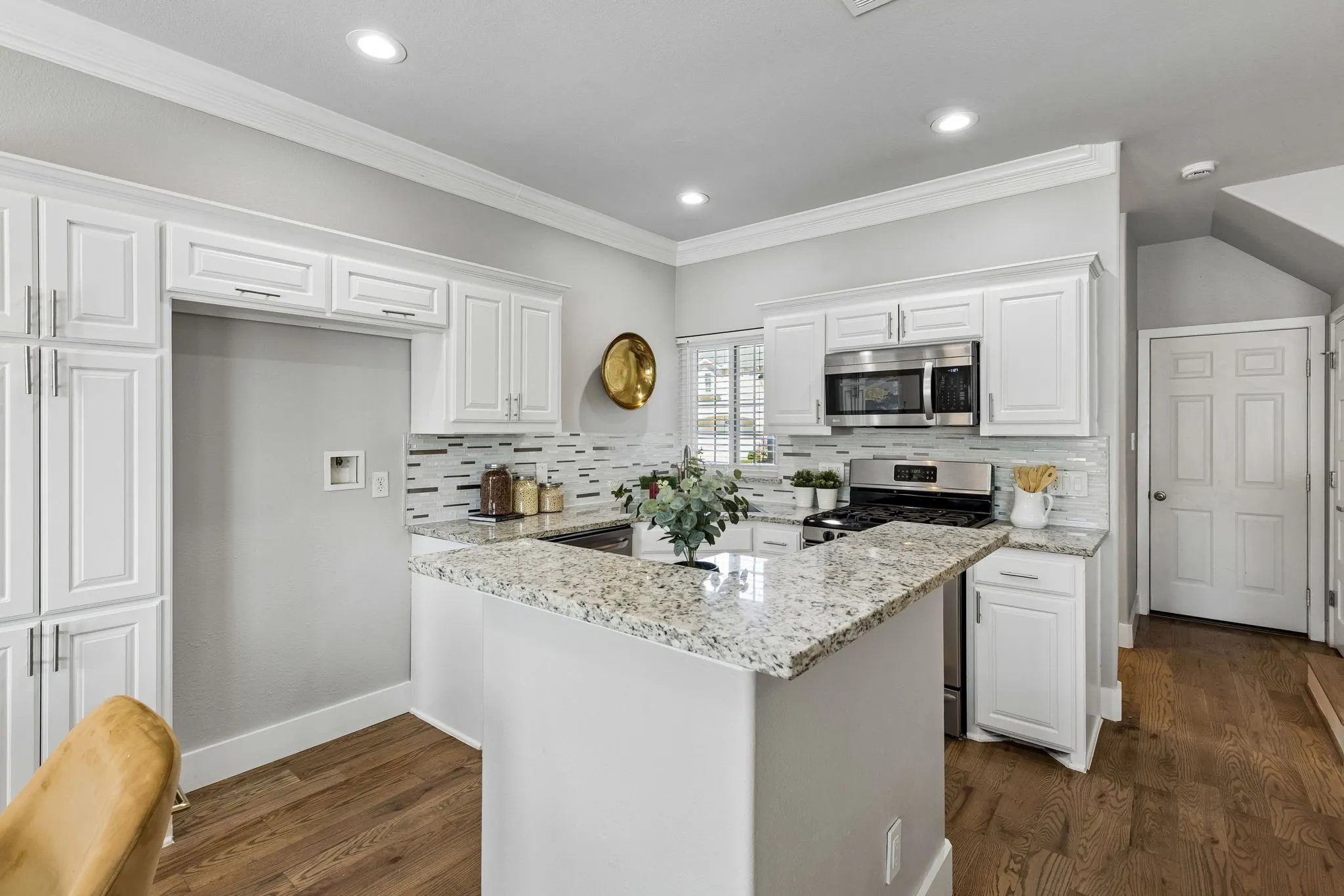 Well lit kitchen with stainless steel appliances