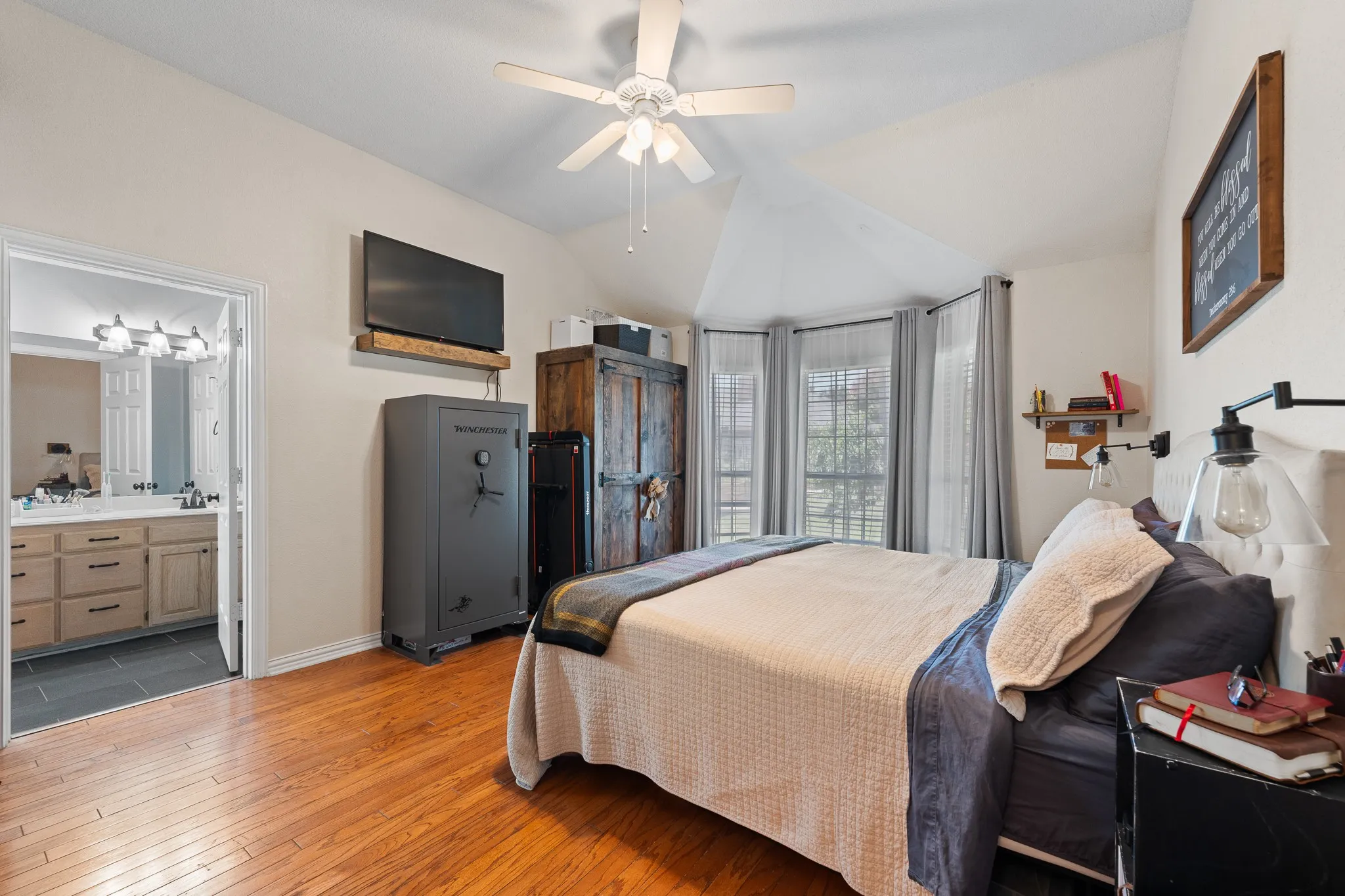 Wood-finish flooring, vaulted ceiling, and ceiling fan