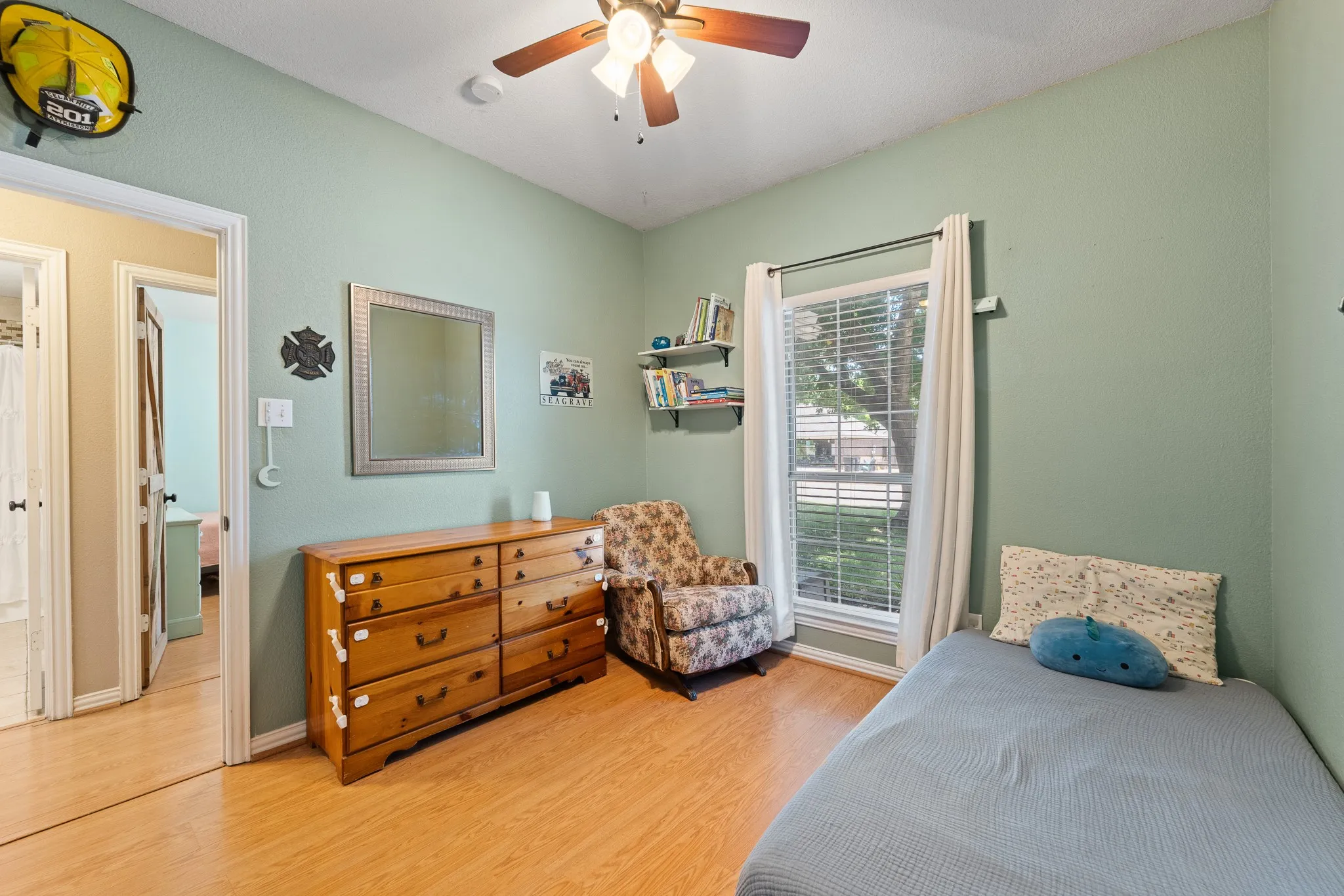 Wood-finish flooring with light green walls