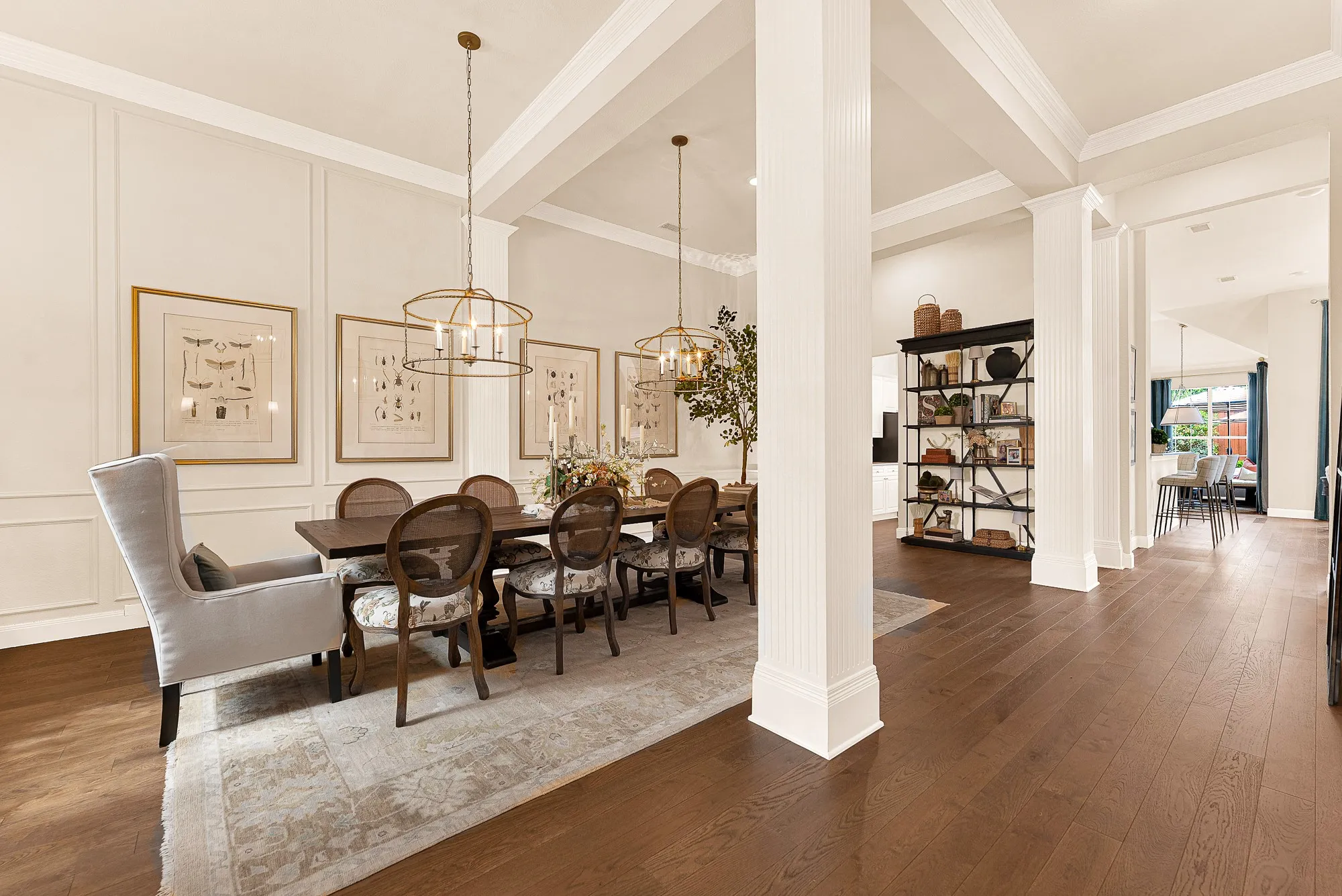 Crisp architectural wainscoting and strong structural pillars seamlessly define the dining quarters while keeping sightlines open toward the back of the home. Visualize hosting holiday meals where conversations flow effortlessly from predinner
drinks into late-night dessert.