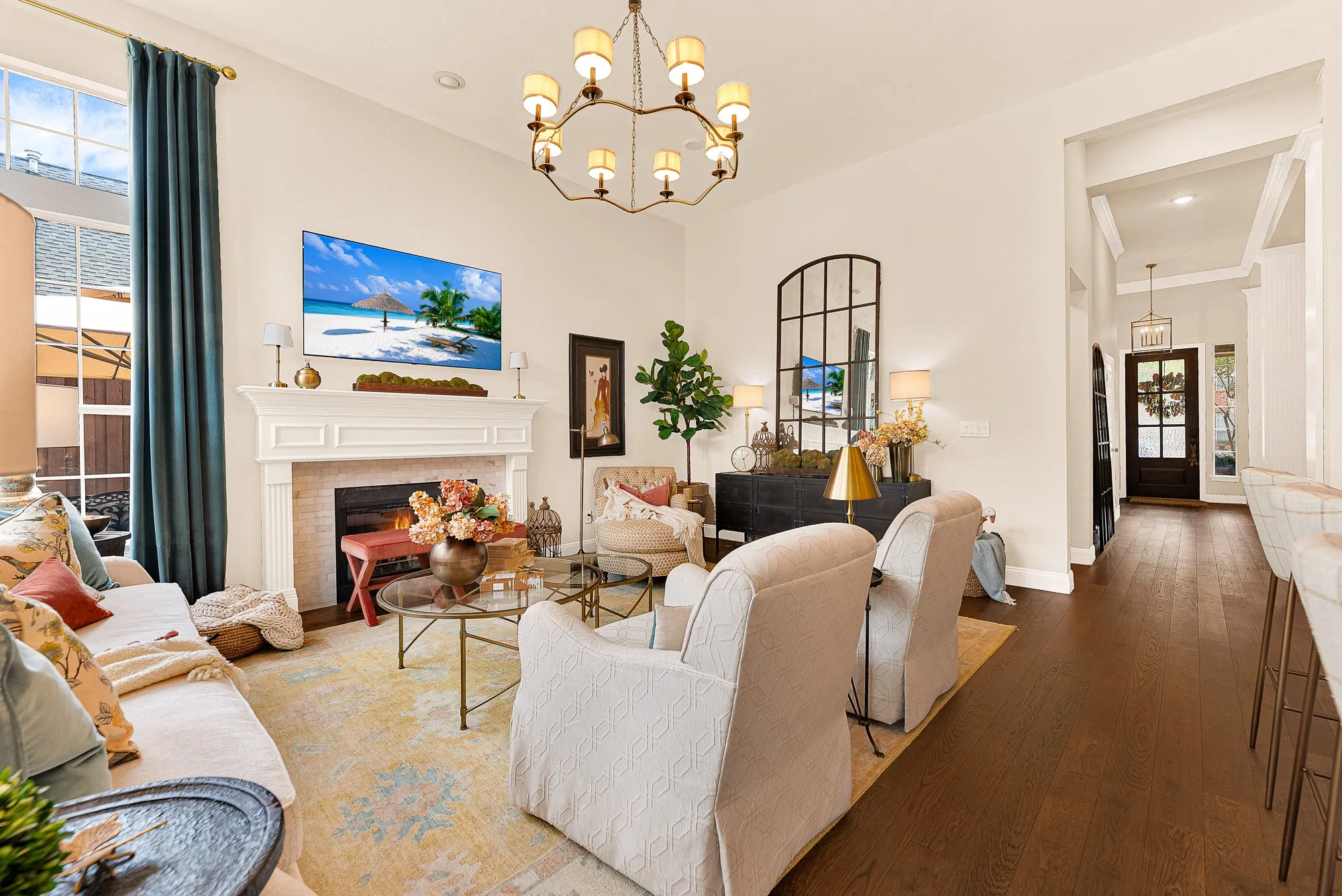 A refined Calcutta marble fireplace surround serves as the focal anchor, balancing clean architectural lines with gentle hearth warmth. Unwind during quiet evenings beside a glowing fire after a long day.