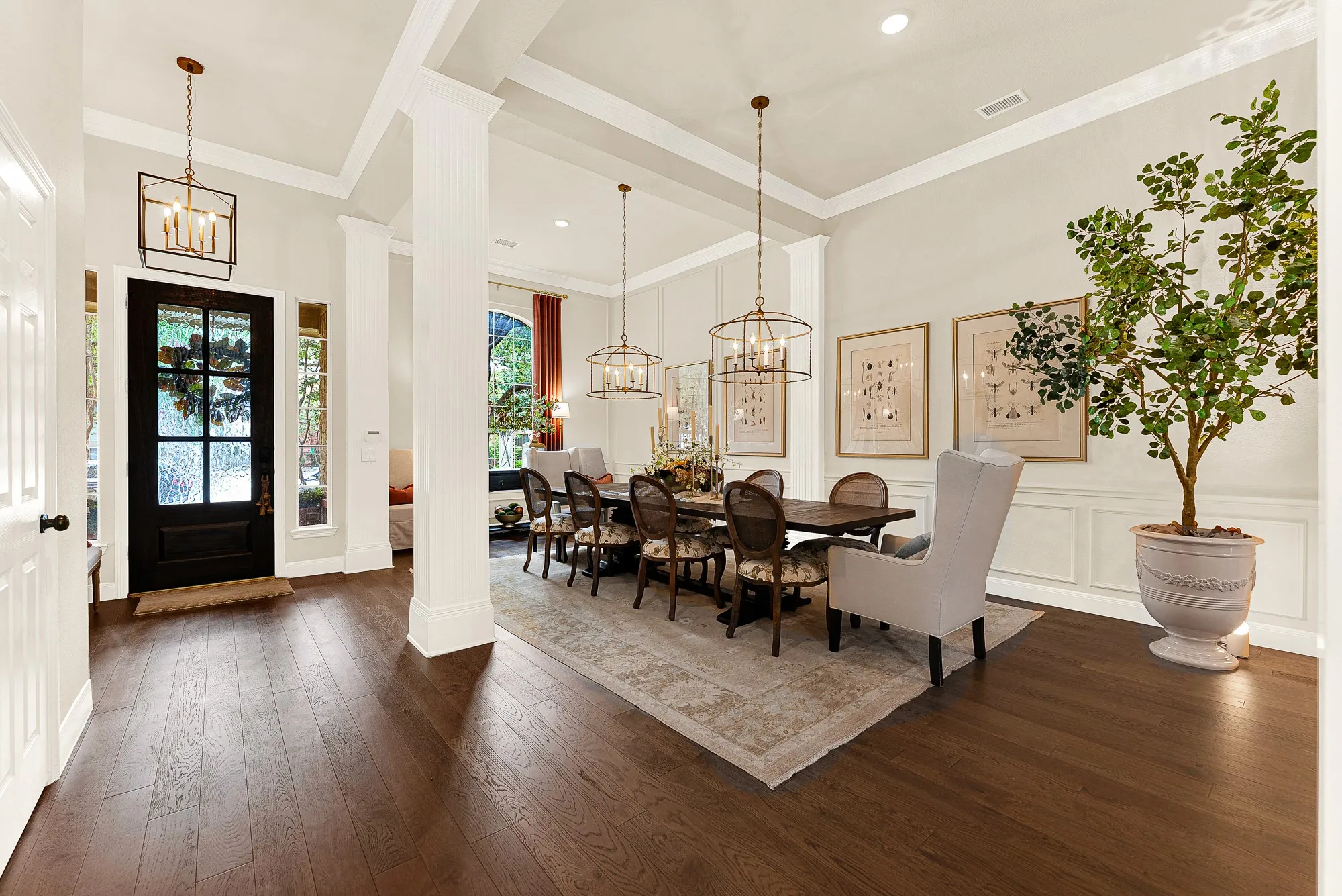 Rich 2024 engineered wood floors anchor the grand entrance, catching soft natural light that filters past classic interior columns. Picture welcoming longtime friends for a festive dinner party as laughter spills naturally across the open floor plan.