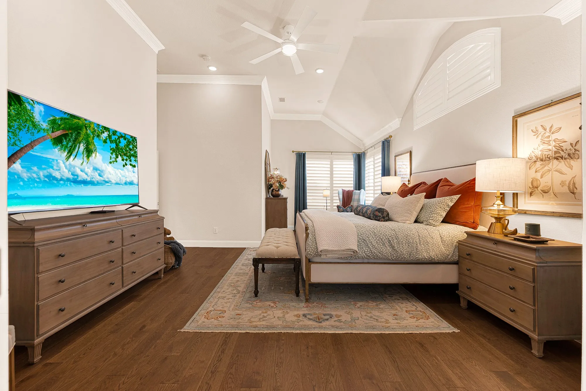 Gleaming hardwood floors and a tall tray ceiling give this primary suite impressive volume and dimension. Unwind  in absolute peace as warm evening light settles across the room.