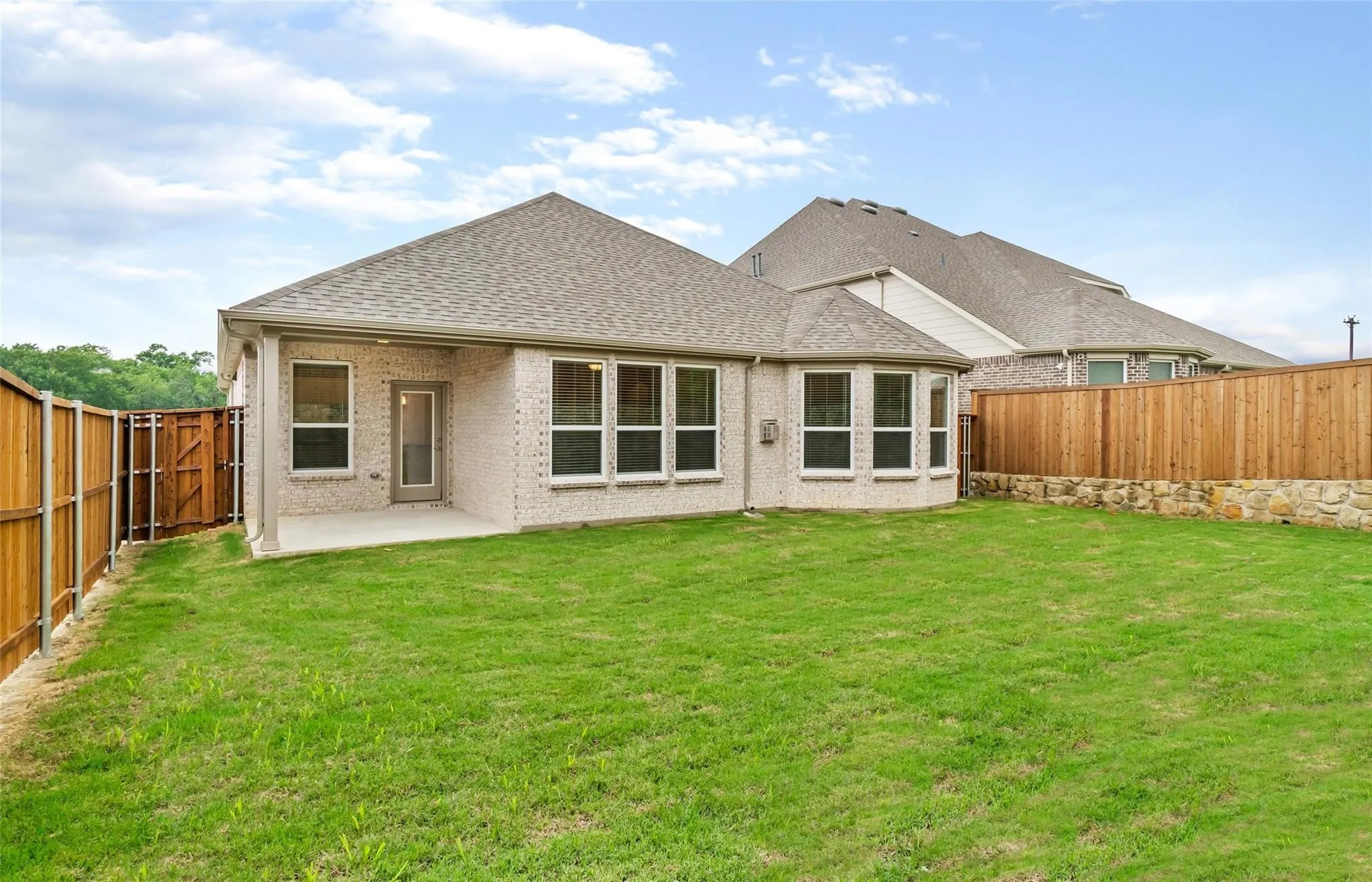 Expansive grassy yard with full fencing