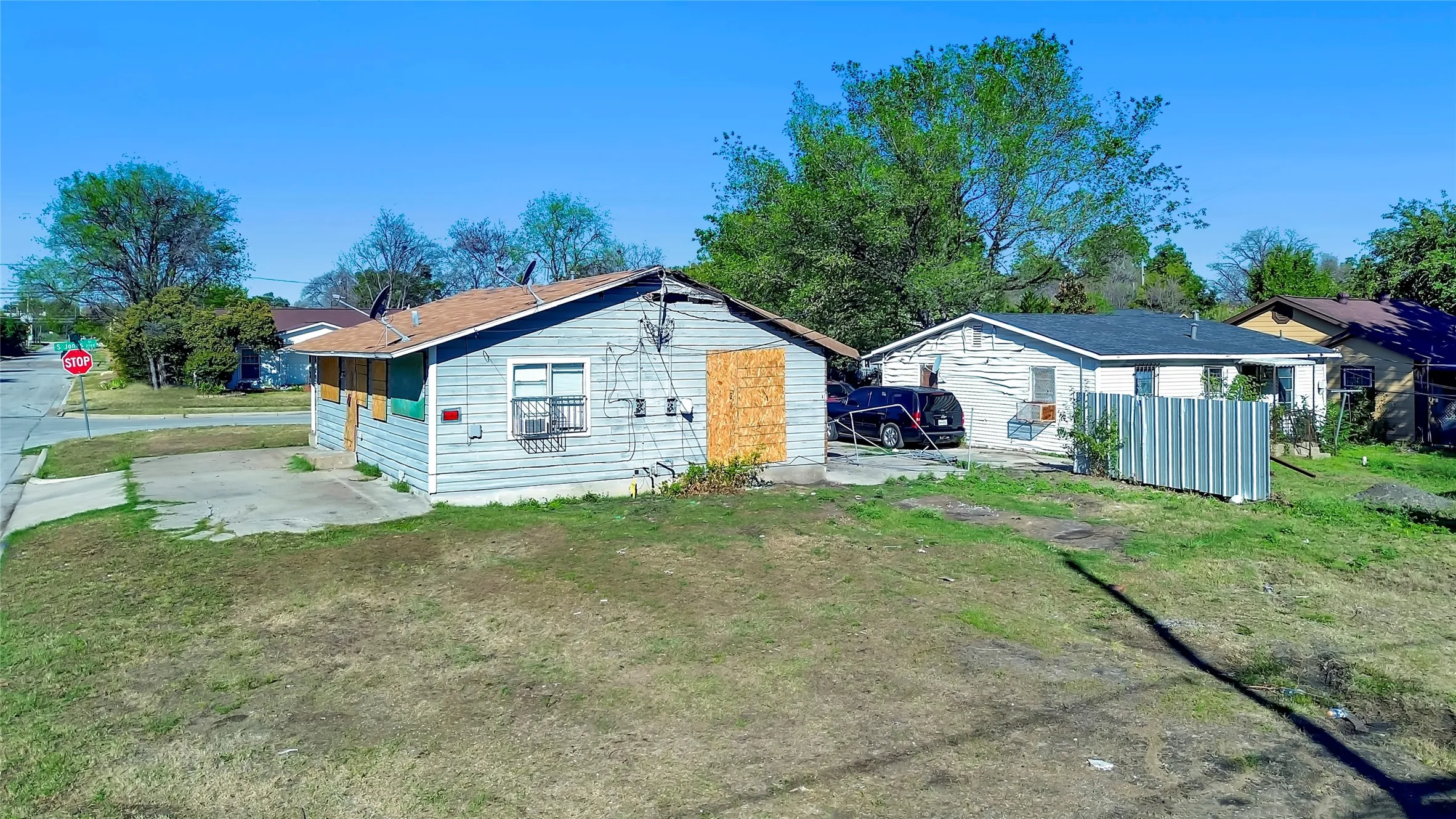 Corner property with a pitched roof and a concrete driveway