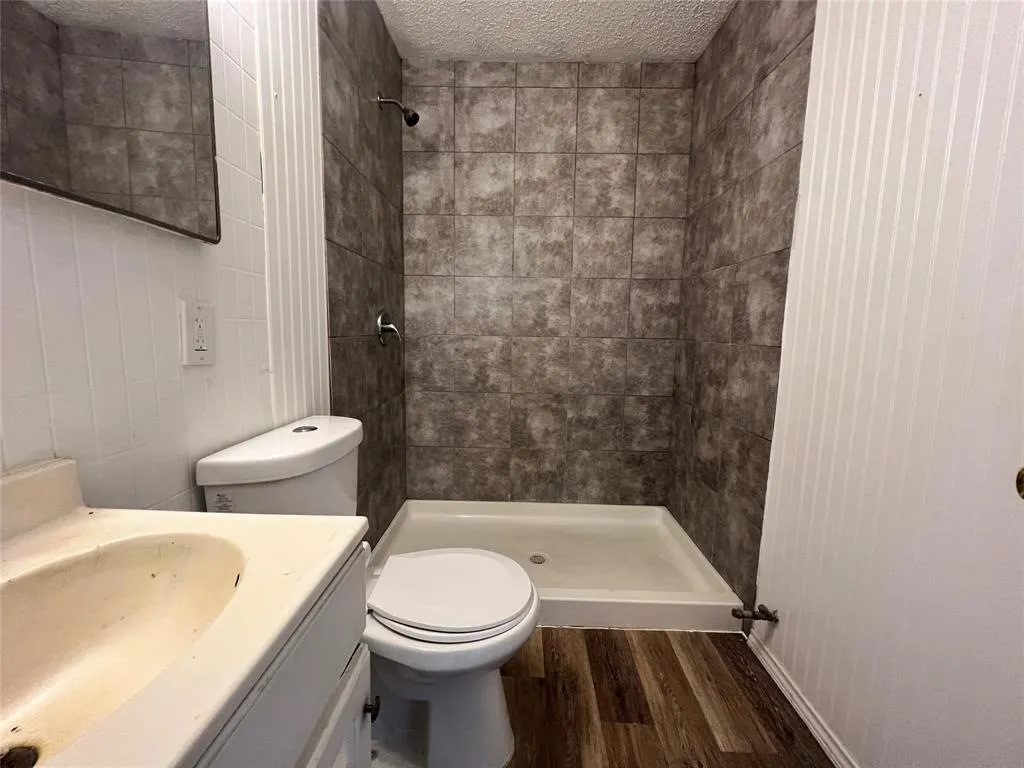 Shower with tiled surround and dark-finish shower head