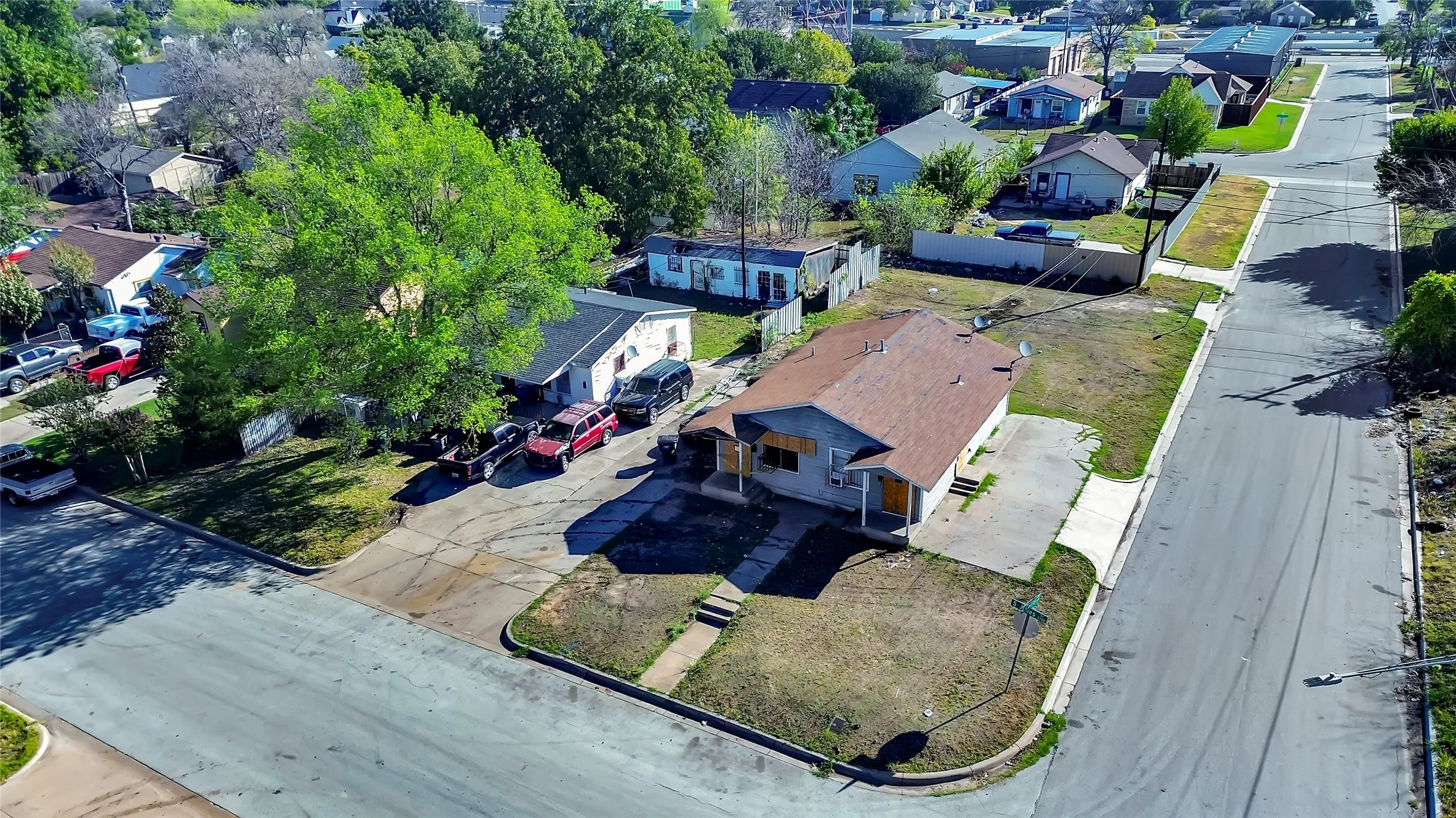 Corner property with a pitched roof and a concrete driveway