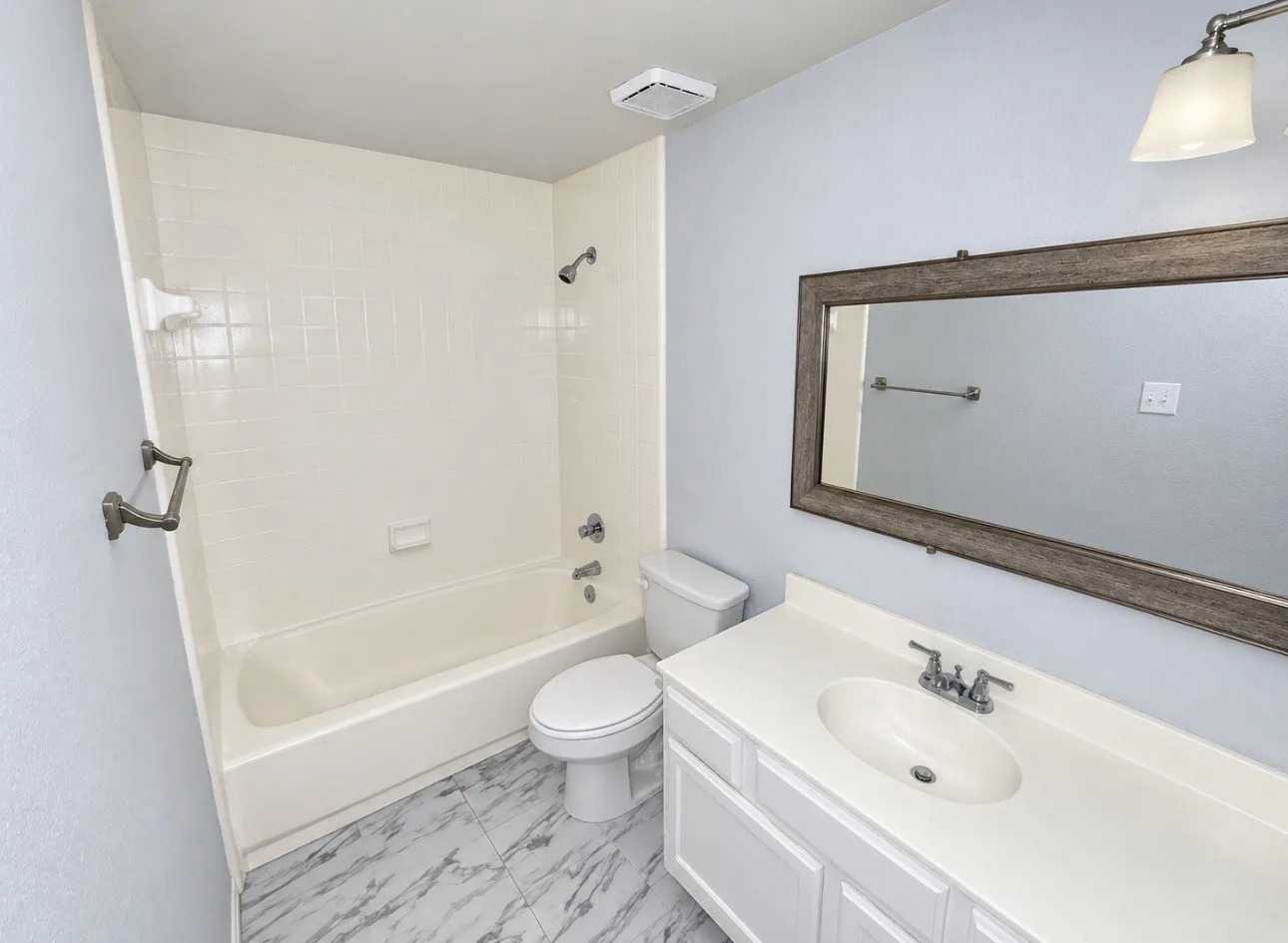 White vanity with an integrated sink and chrome fixtures