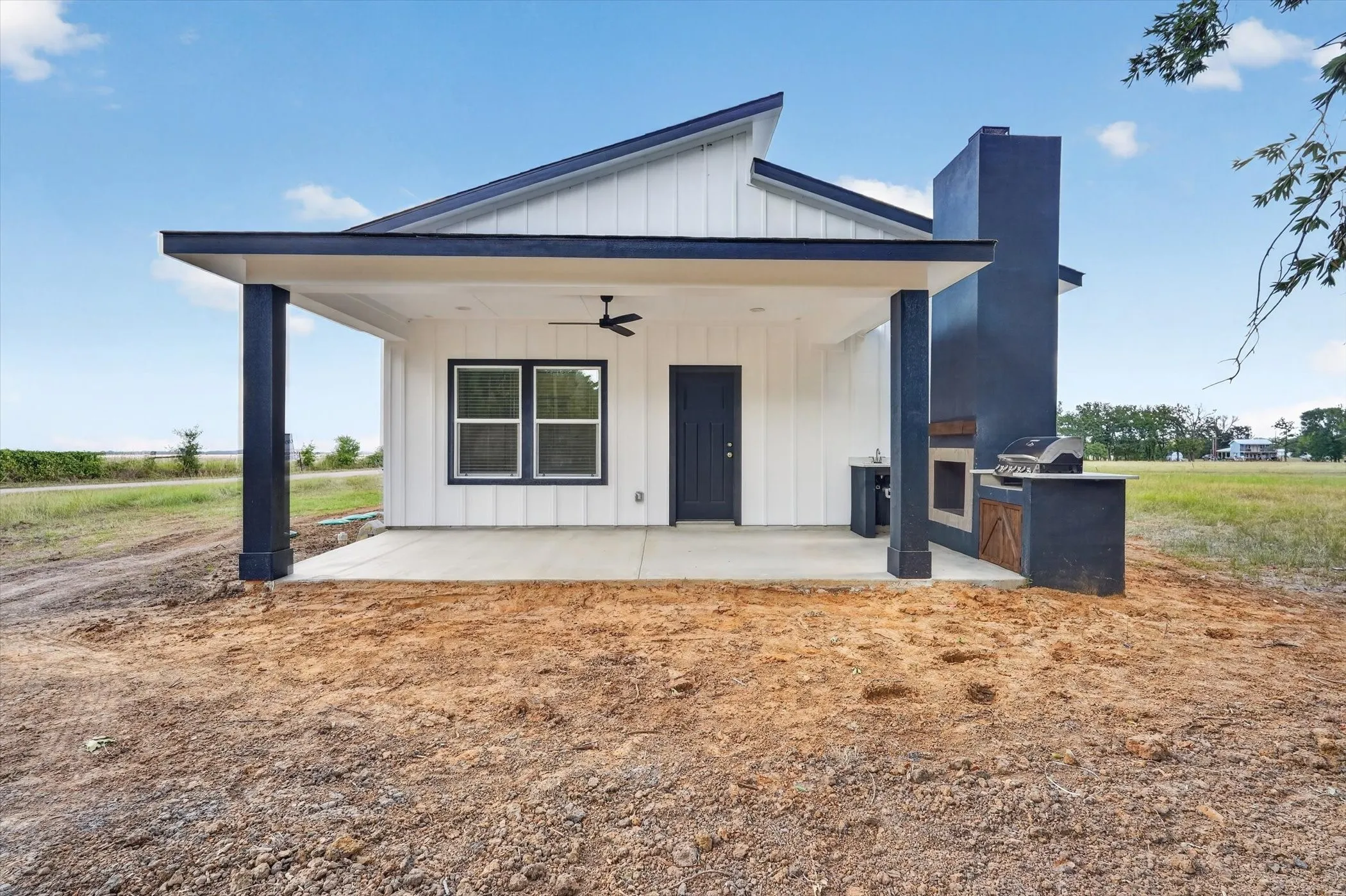 Pitched roofline with dark trim and white vertical siding