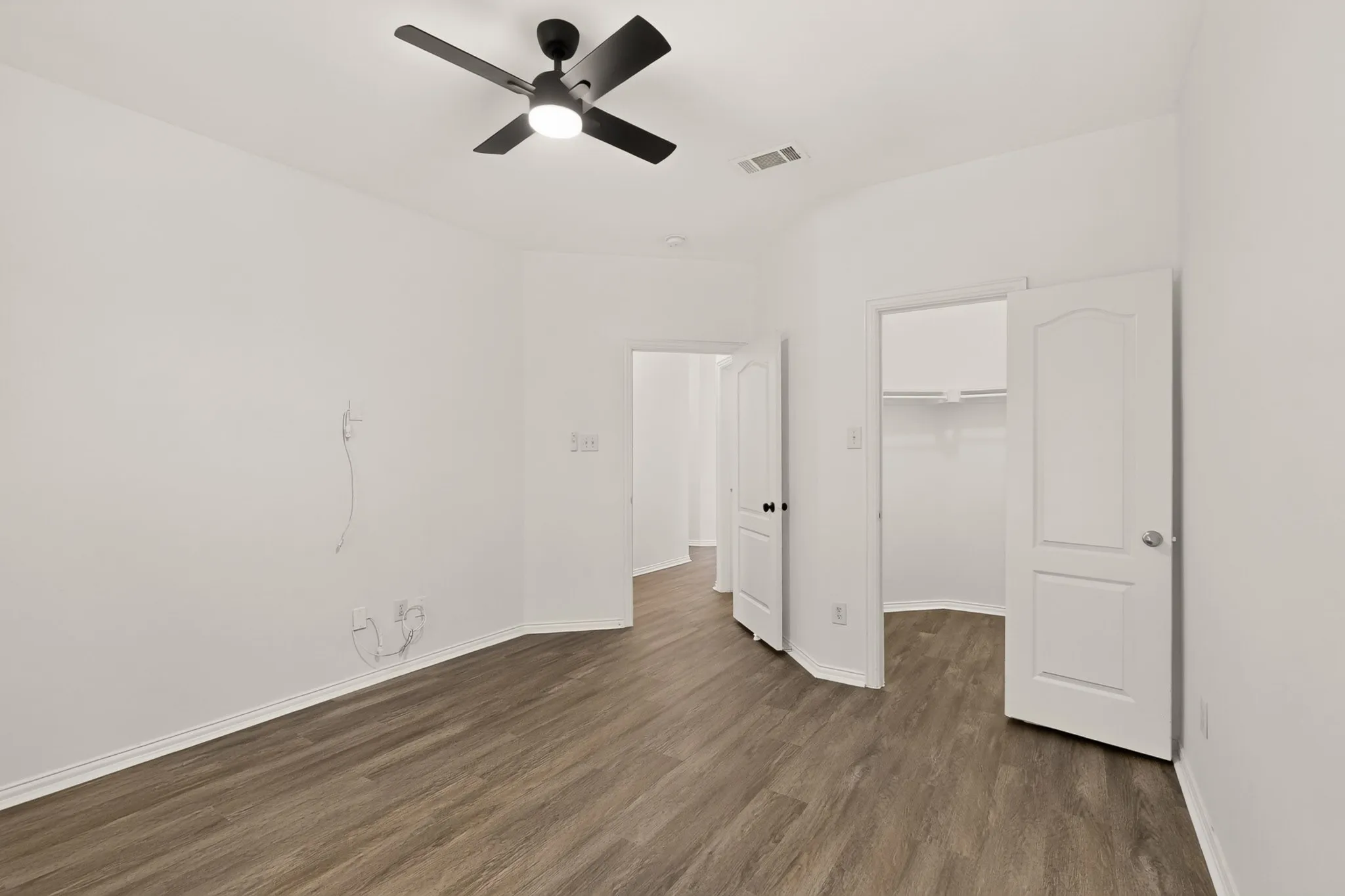 Wood-finish flooring with crisp white walls and white trim