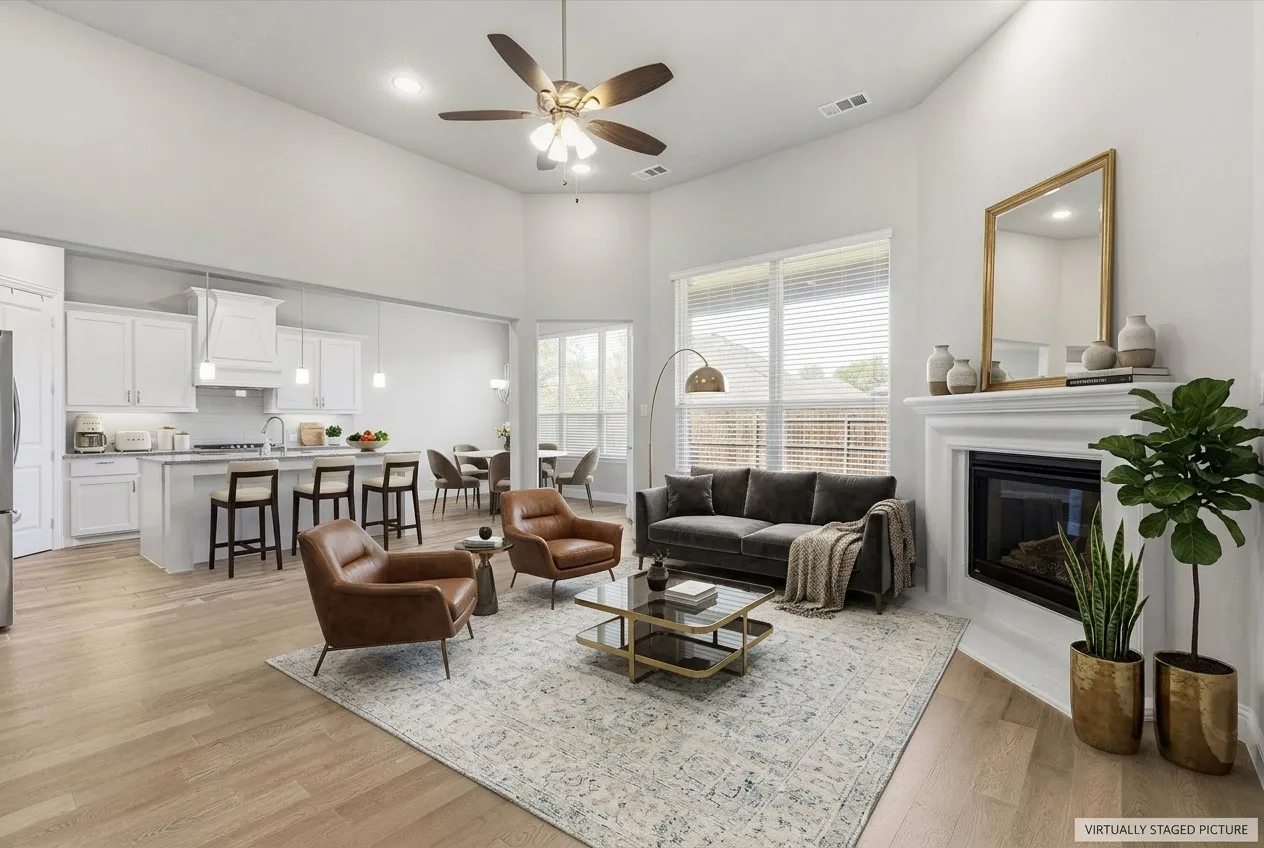Virtually Staged Picture - Vaulted ceilings, wood-finish flooring, fireplace with mantel, recessed lighting, and ceiling fan