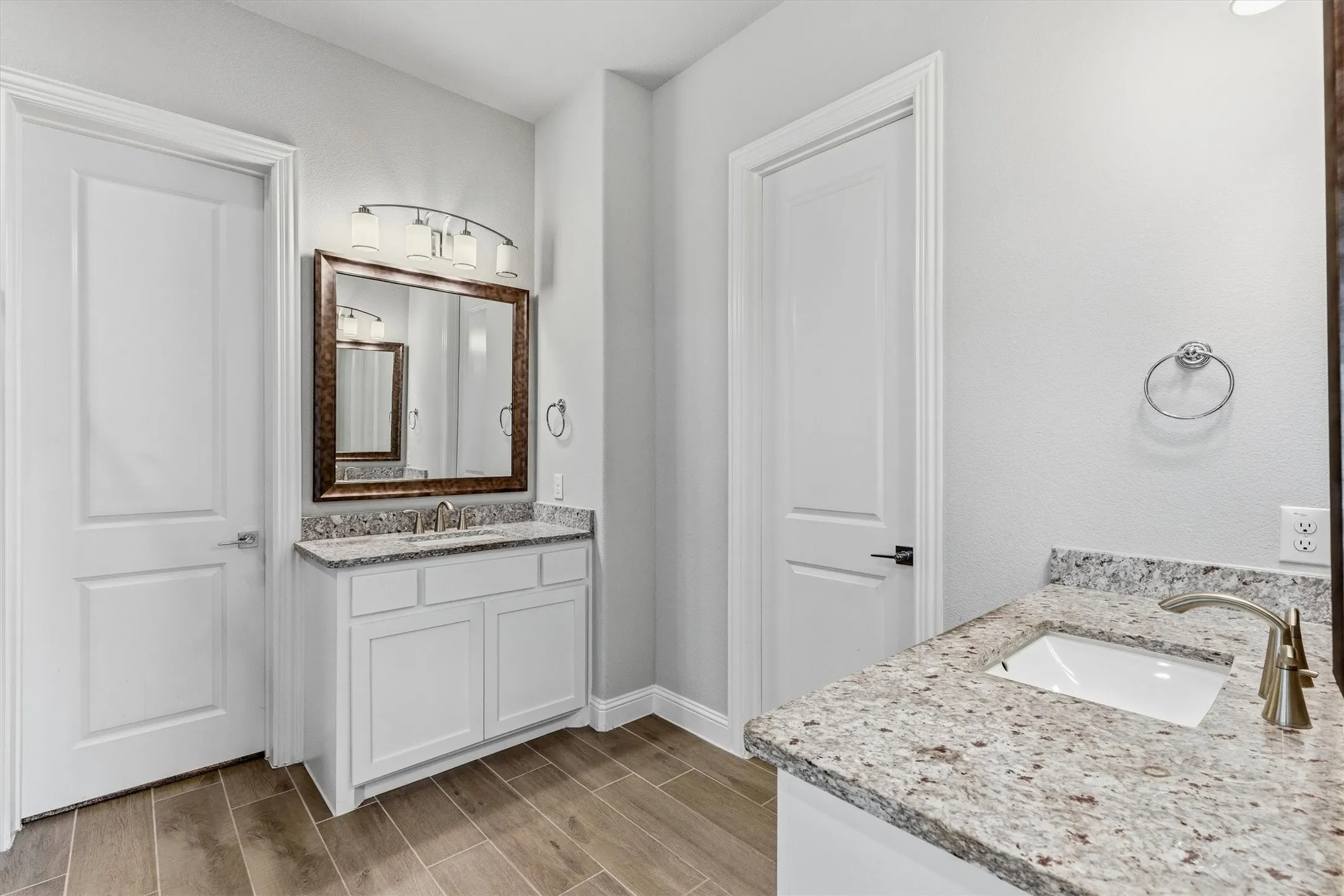Dual vanities with granite countertops