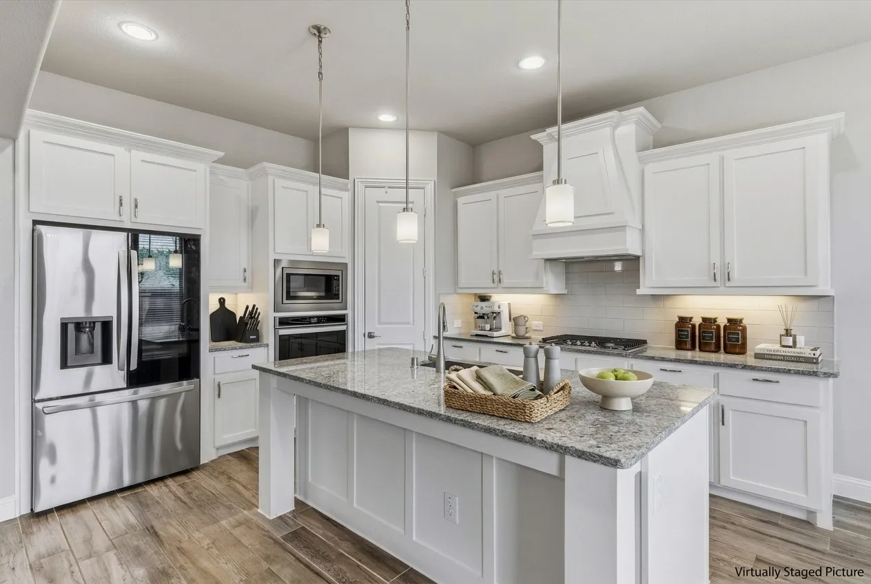 Virtually Staged Picture - Kitchen featuring stainless steel appliances, white cabinetry, granite countertops, wood-finish flooring, and pendant lighting