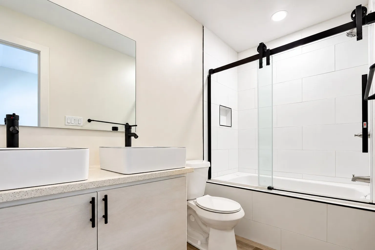 Dual rectangular vessel sinks with matte black faucets