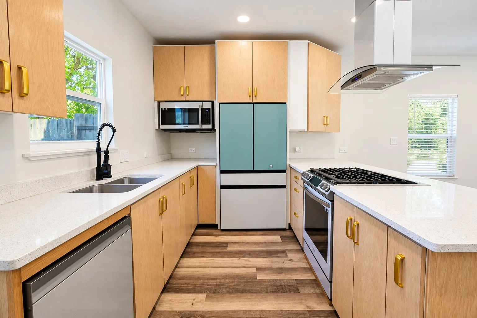 Kitchen featuring wood-finish cabinetry, light-toned countertops, and wood-finish flooring