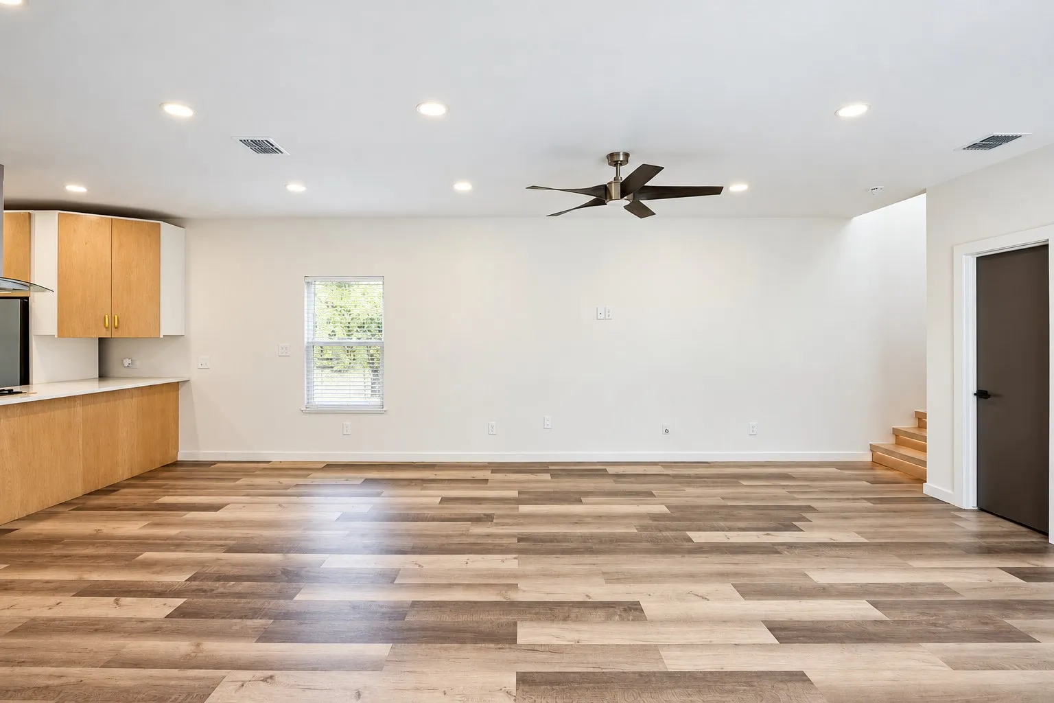 Wood-finish flooring, recessed lighting, and a modern ceiling fan