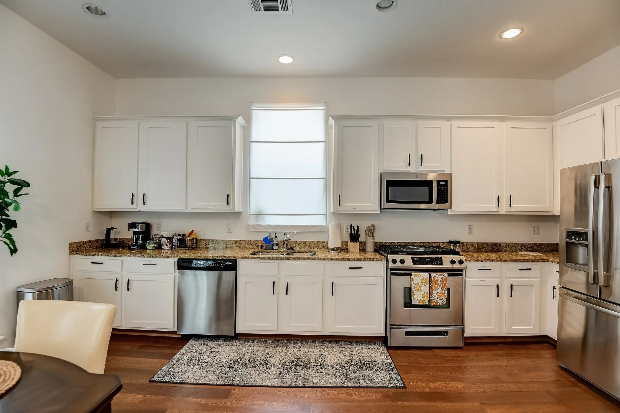 Kitchen featuring stainless steel appliances, a sink, white cabinetry, and recessed lighting