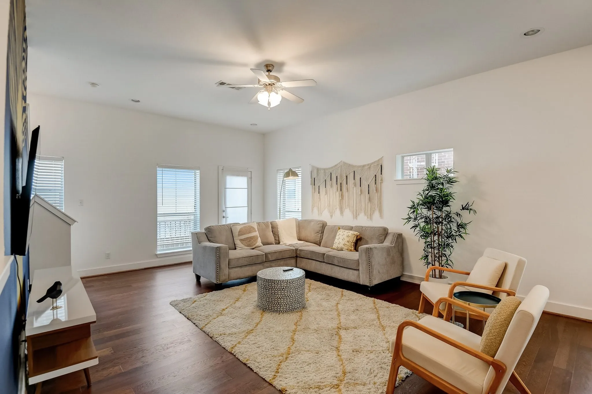 Living area with a ceiling fan, dark wood-style floors, baseboards, and recessed lighting