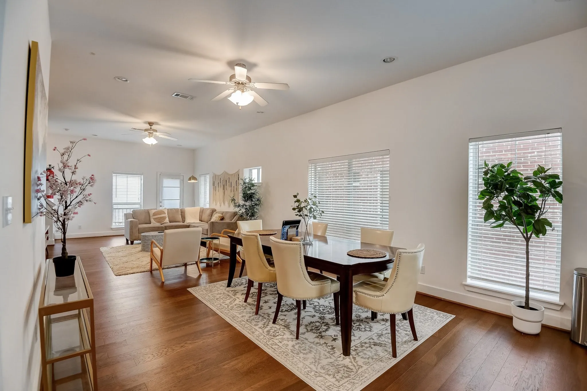 Dining room with dark wood-style floors, ceiling fan, and baseboards