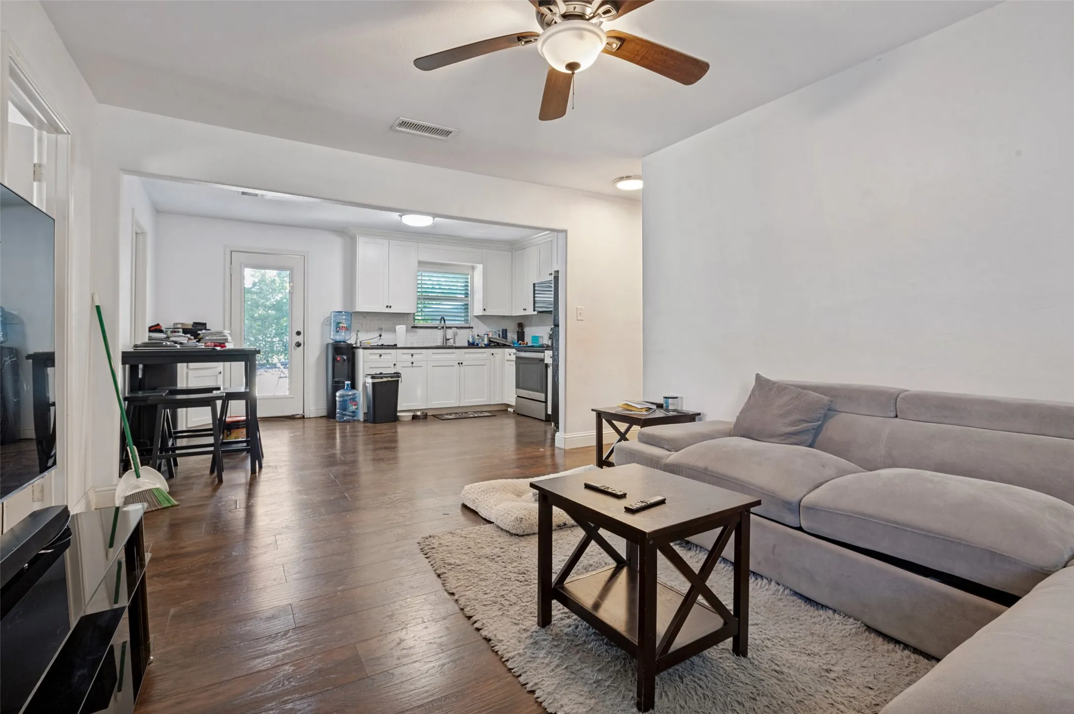 Open-concept living area featuring wood-finish flooring, a ceiling fan, and recessed lighting