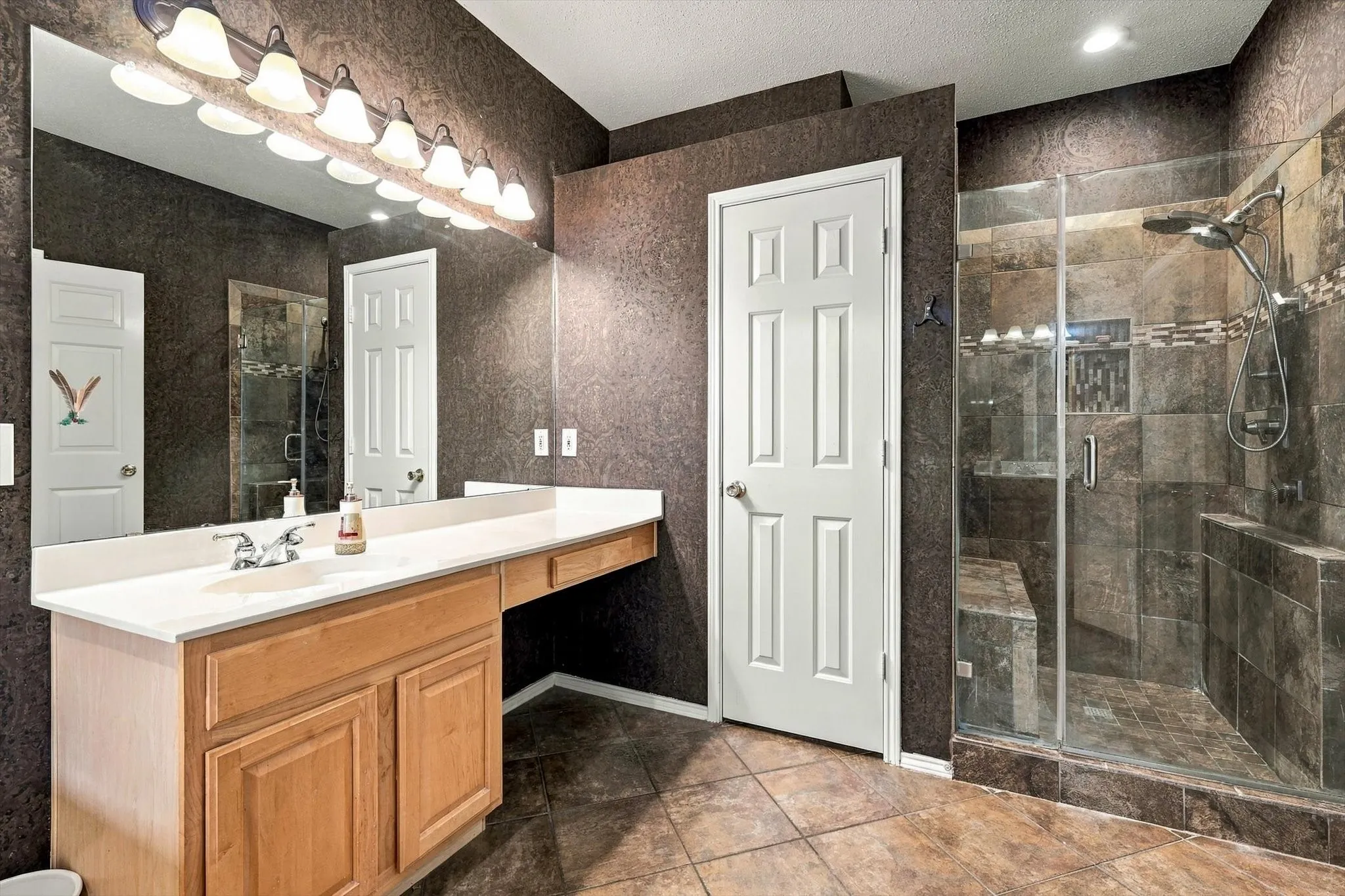 Double vanity with undermount sink and light-toned countertop