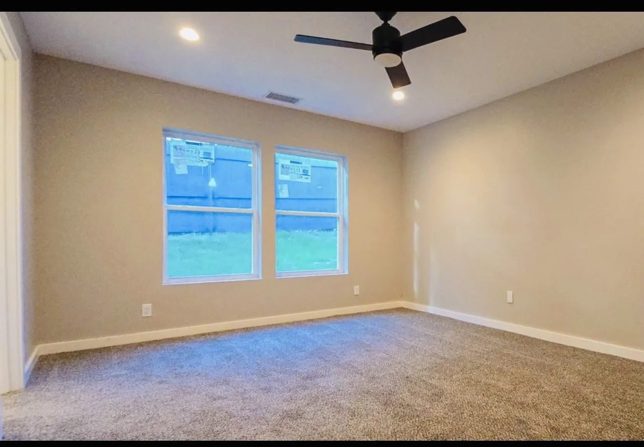 Plush carpet flooring, recessed ceiling lighting, and a contemporary black ceiling fan