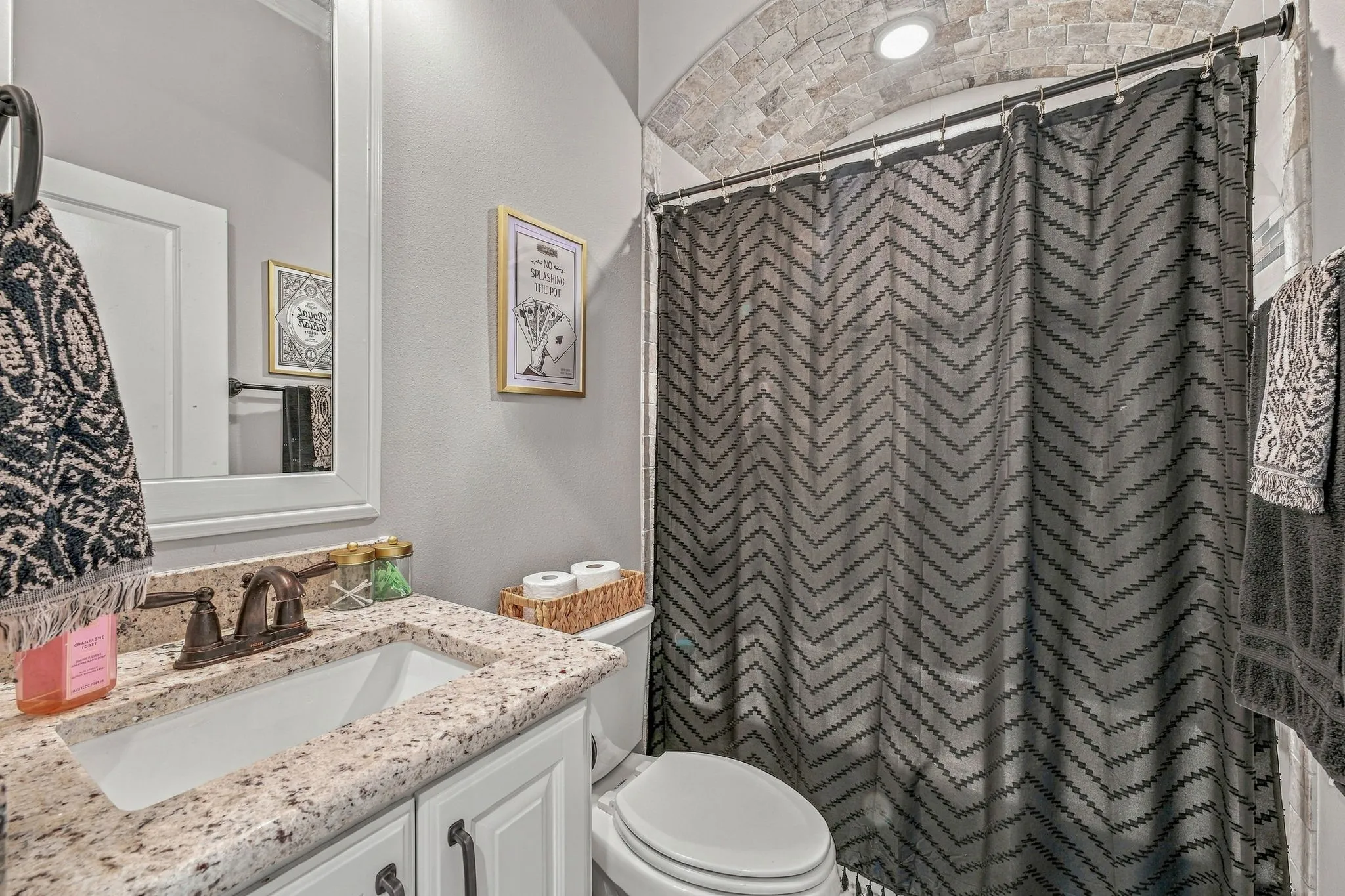 White vanity with granite countertop and undermount sink
