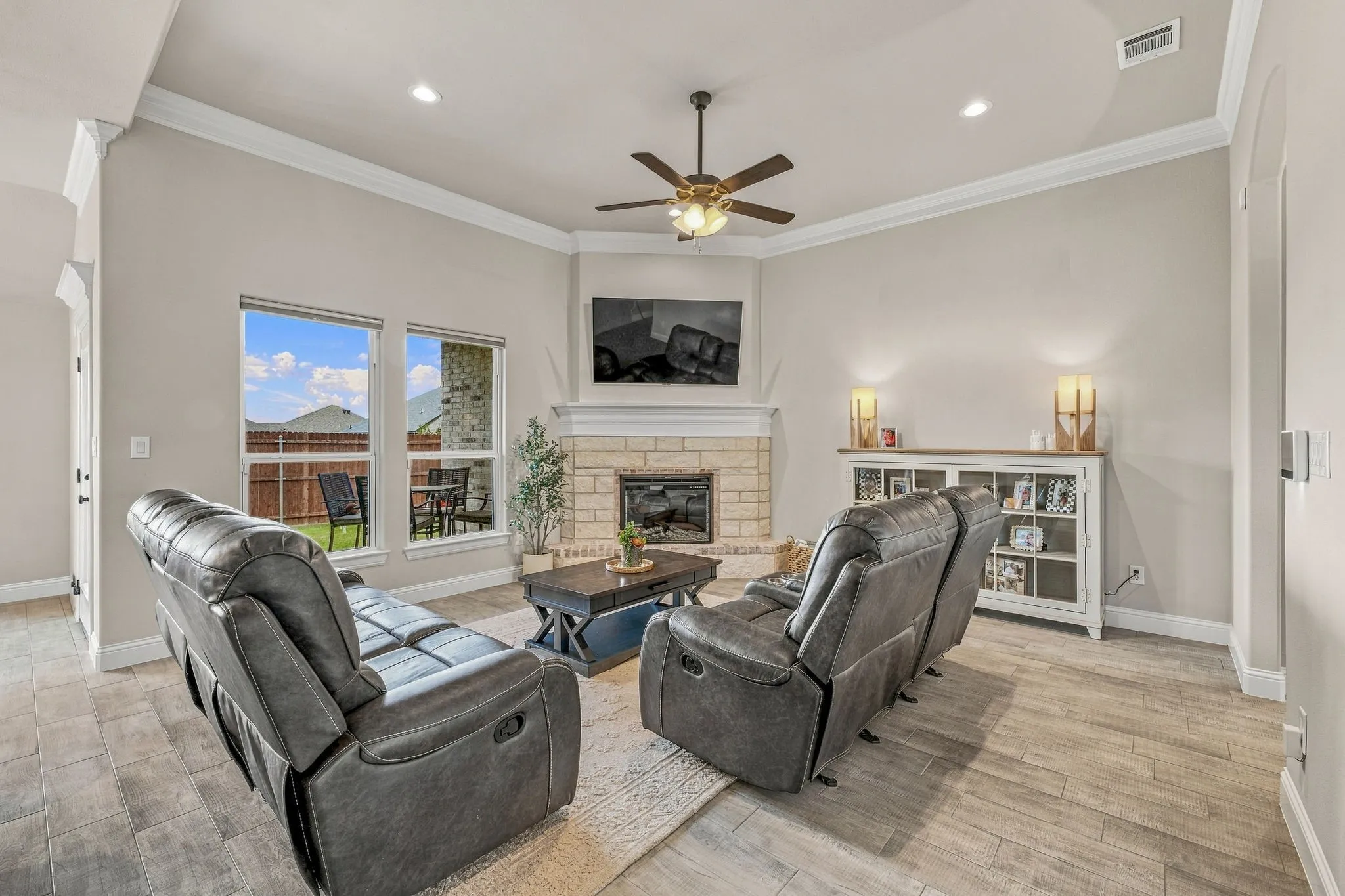 Vaulted ceiling with crown molding, ceiling fan, and recessed lighting