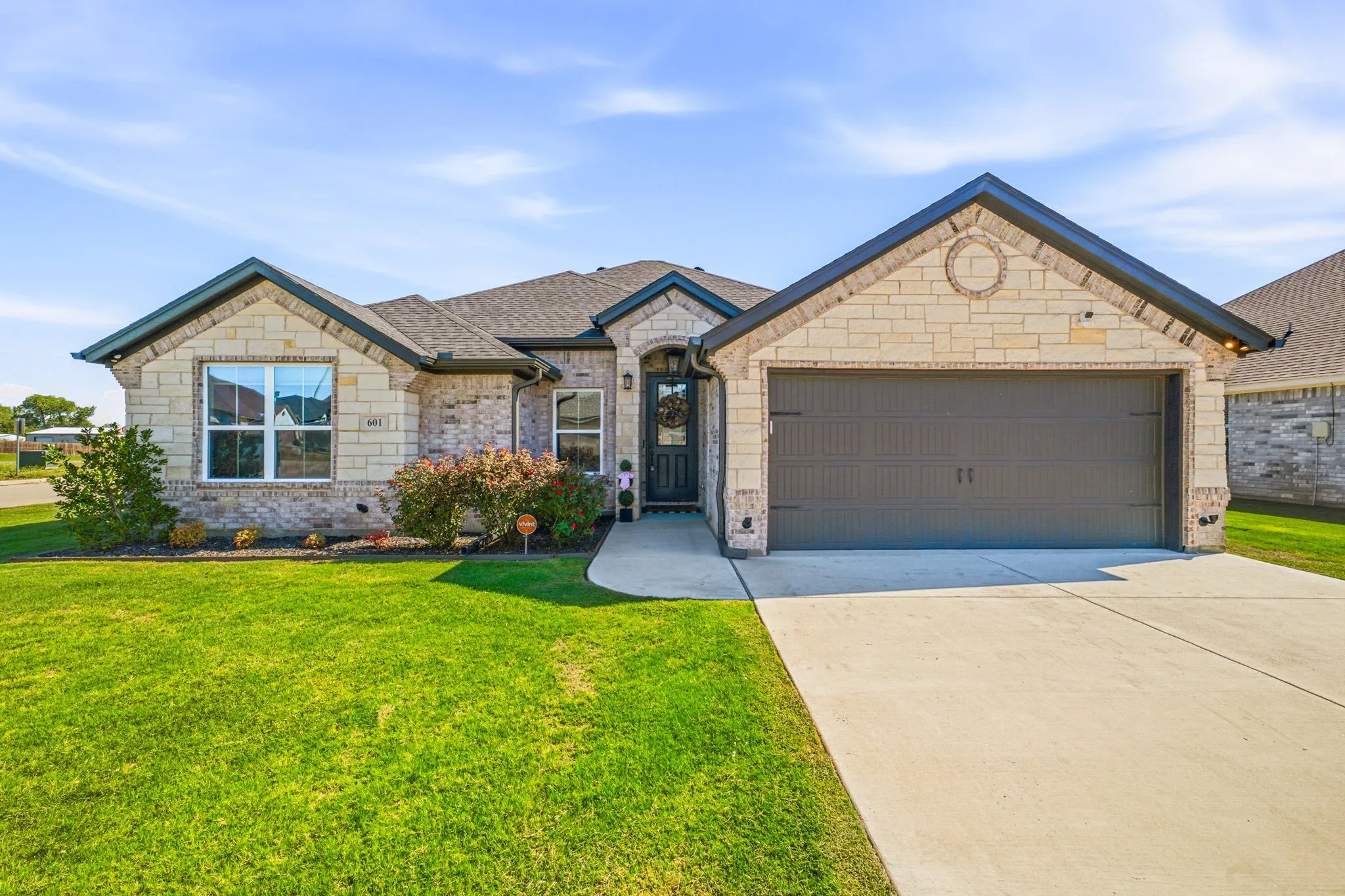 Stone and brick exterior with dark trim and a gabled roof