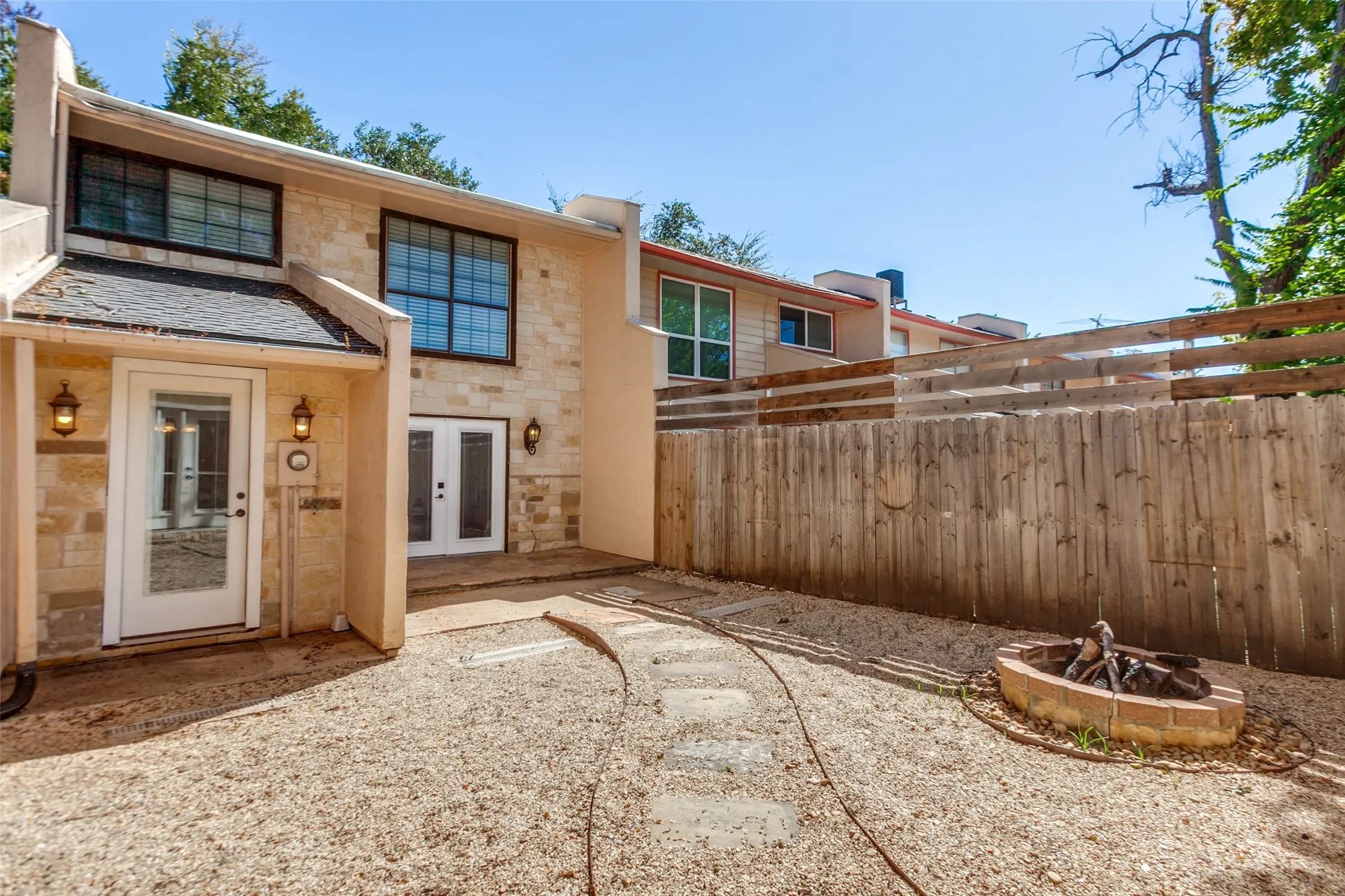 351 Vally Park Dr. - Back of home featuring a low-maintenance backyard with a fire pit, perfect for relaxing or entertaining outdoors.