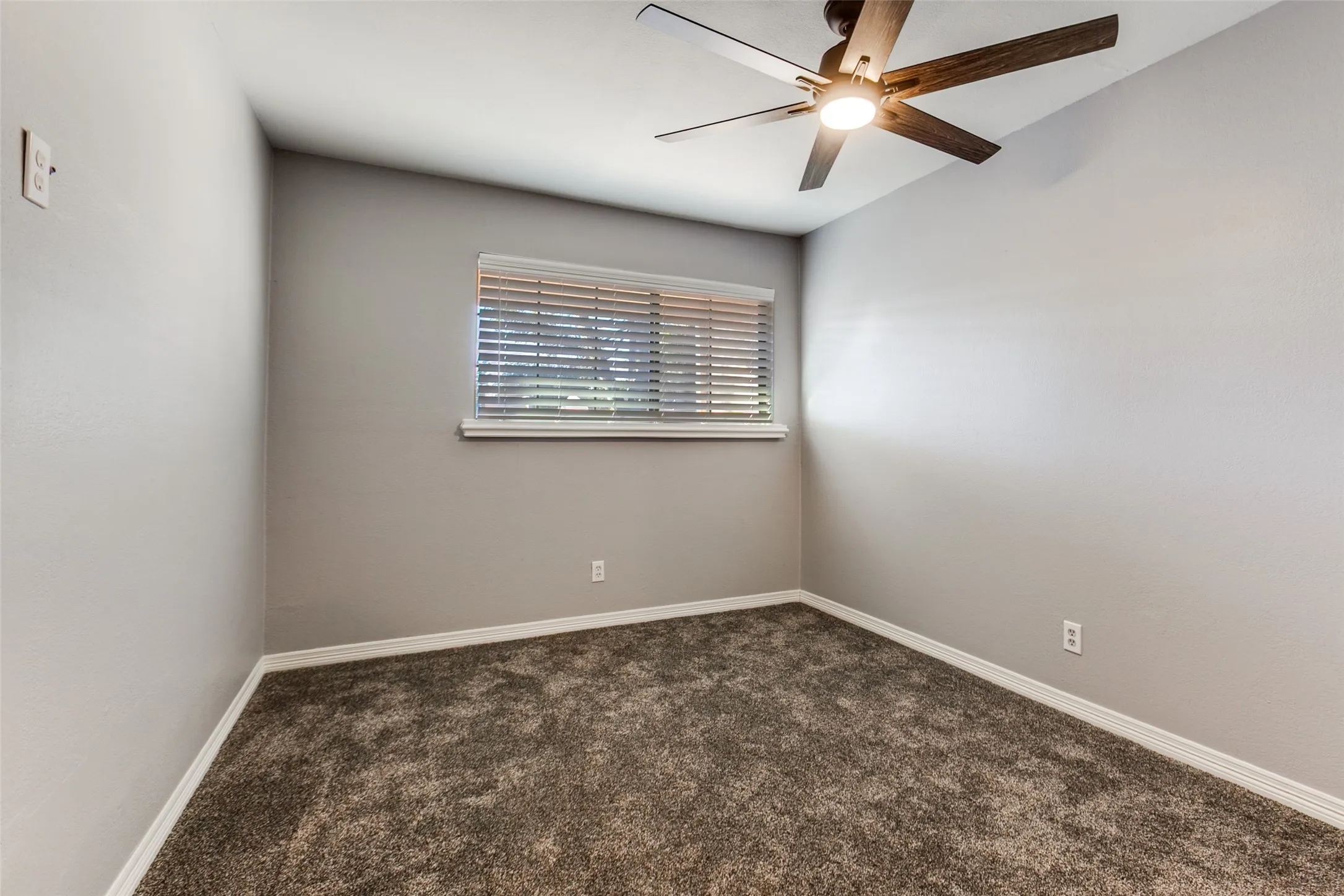351 Vally Park Dr. - Second-floor bedroom featuring newer carpet, a ceiling fan, and a window overlooking the backyard.