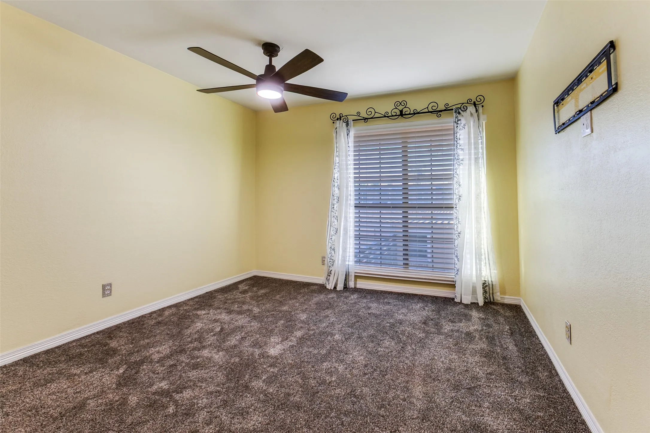 351 Vally Park Dr. - Second-floor bedroom featuring newer carpet, a ceiling fan, and a window overlooking the backyard.