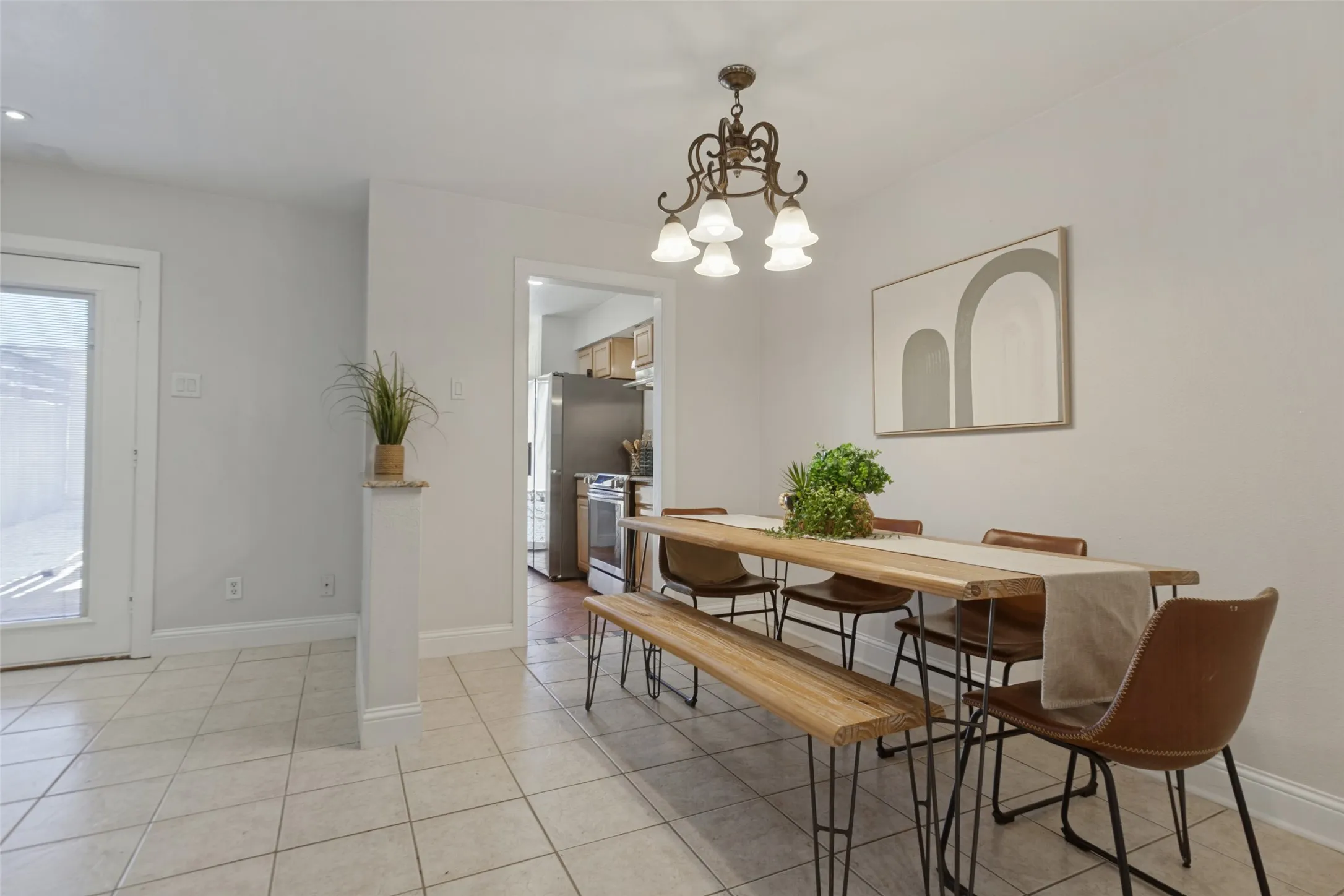 351 Vally Park Dr. - Dining area featuring newer tile flooring and a stylish chandelier, creating a bright and inviting space for everyday meals or entertaining.