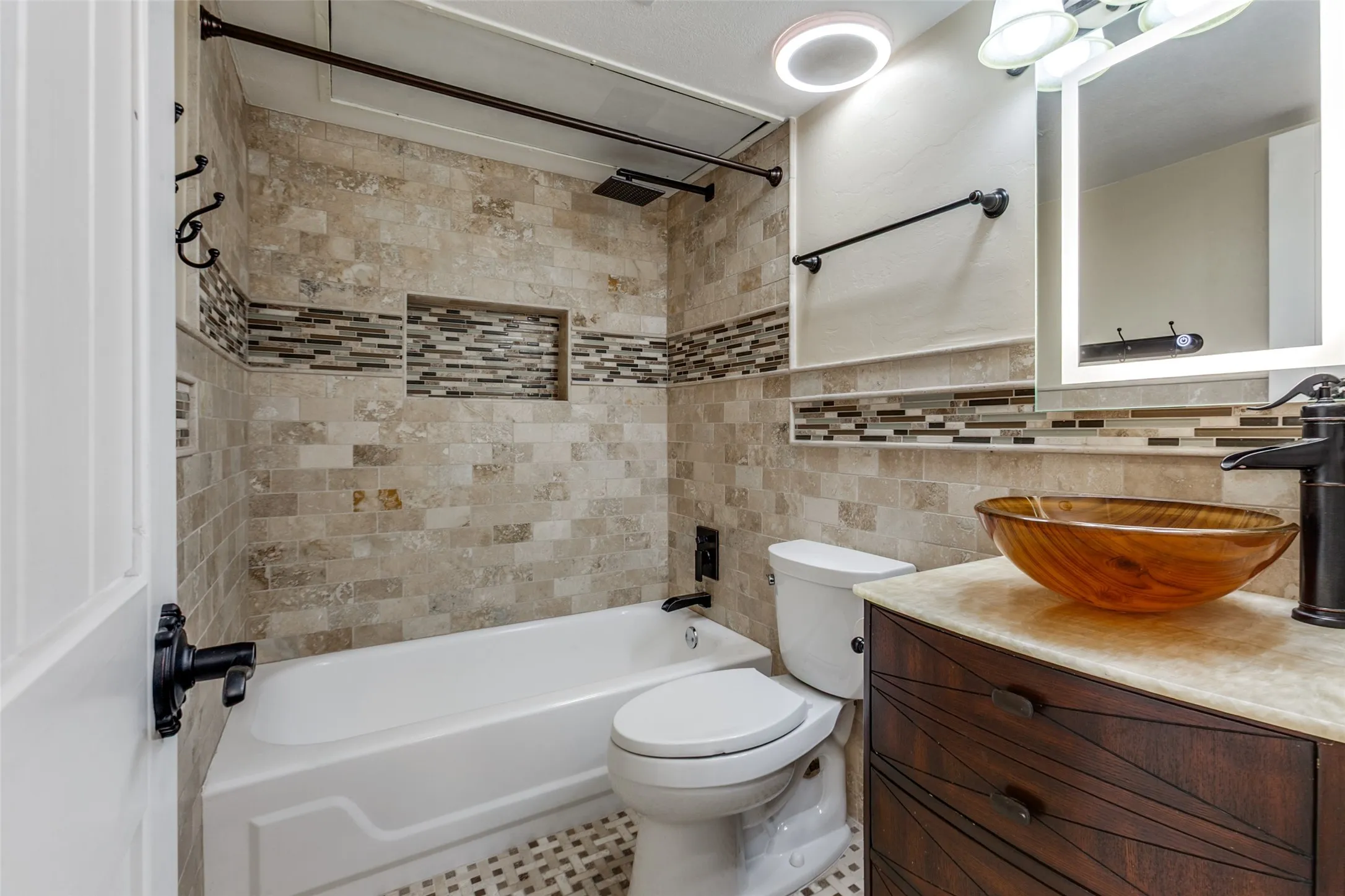 351 Valley Park Dr. - 2nd floor bathroom featuring a beautifully updated bathtub, decorative mosaic tile accents, rustic wood vanity with vessel sink, and stylish fixtures.
