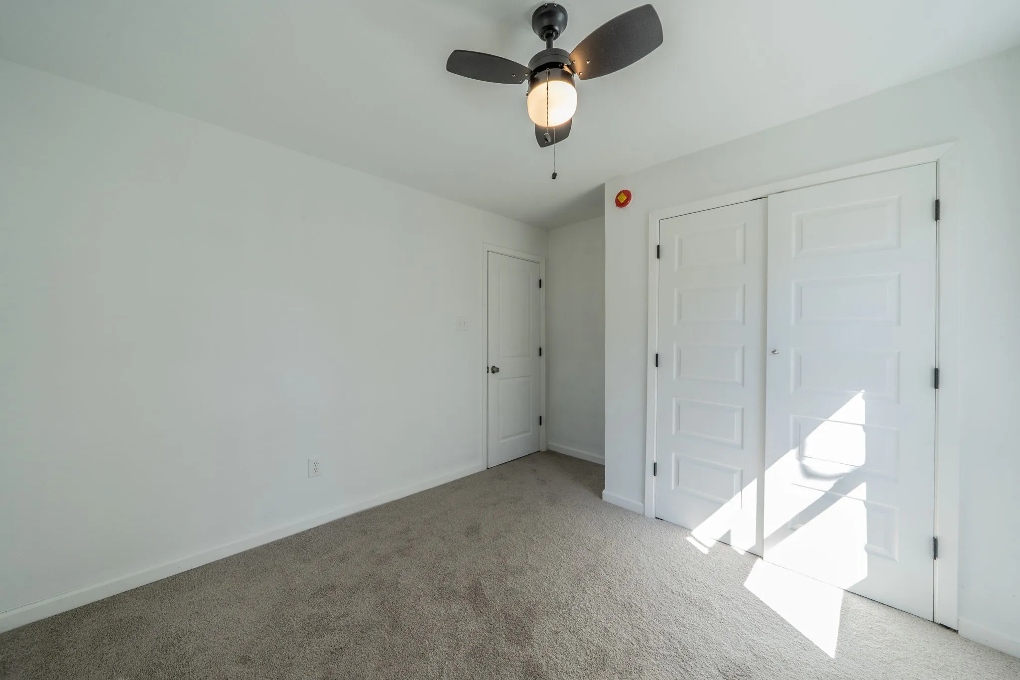White walls with a textured gray carpet