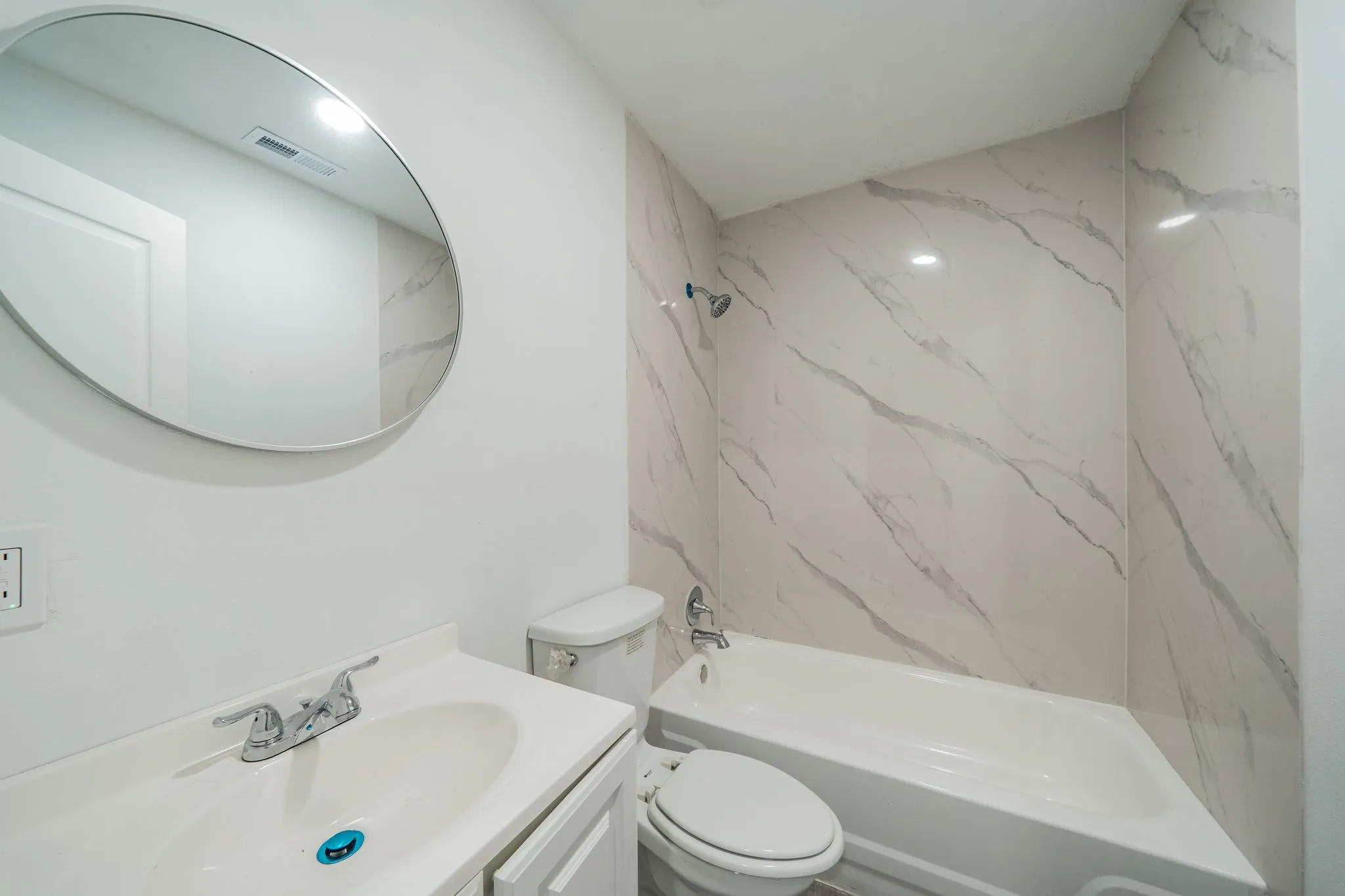 White vanity with an integrated sink and chrome faucet