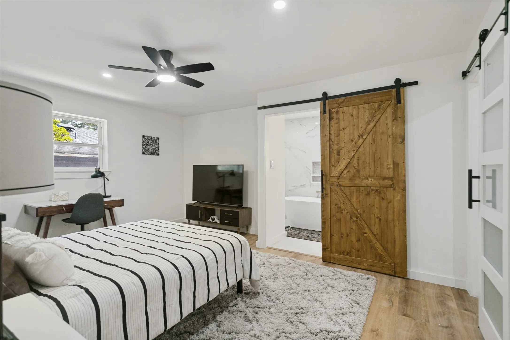 Recessed lighting, wood-finish flooring, and a contemporary ceiling fan