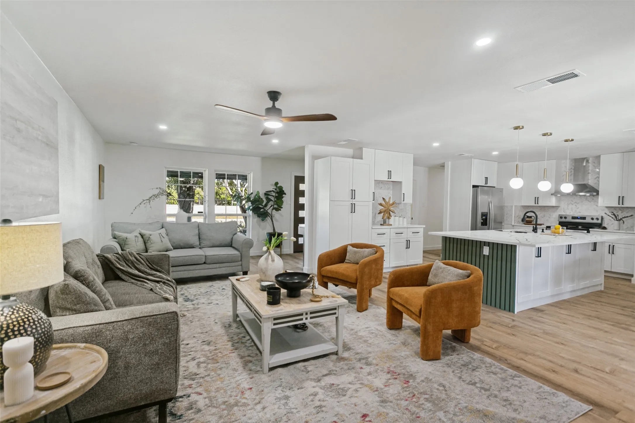 Open-concept living space with recessed lighting, wood-finish flooring, and a modern ceiling fan