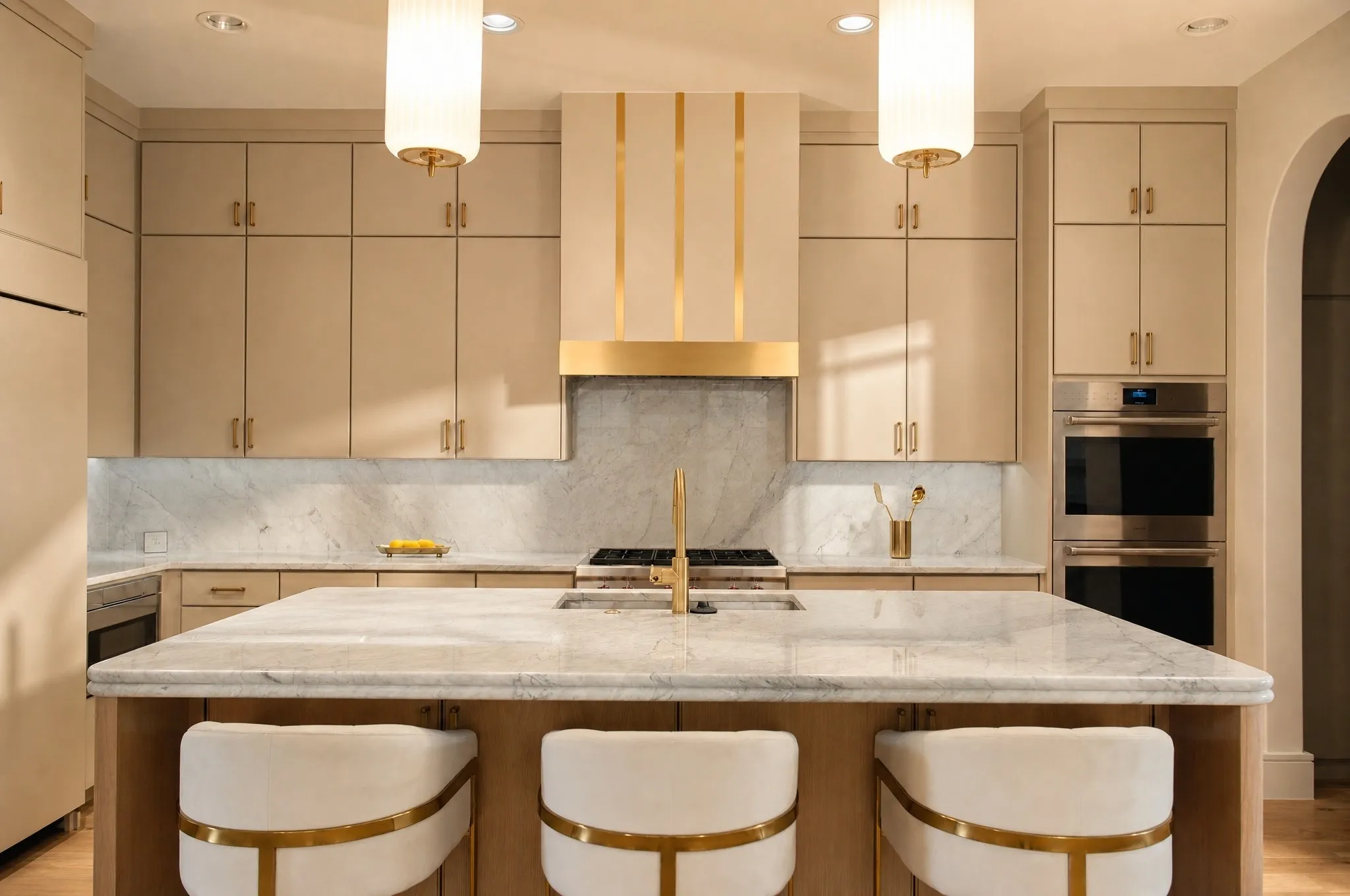 Expansive kitchen island with a stone countertop, featuring a built-in range and integrated sink