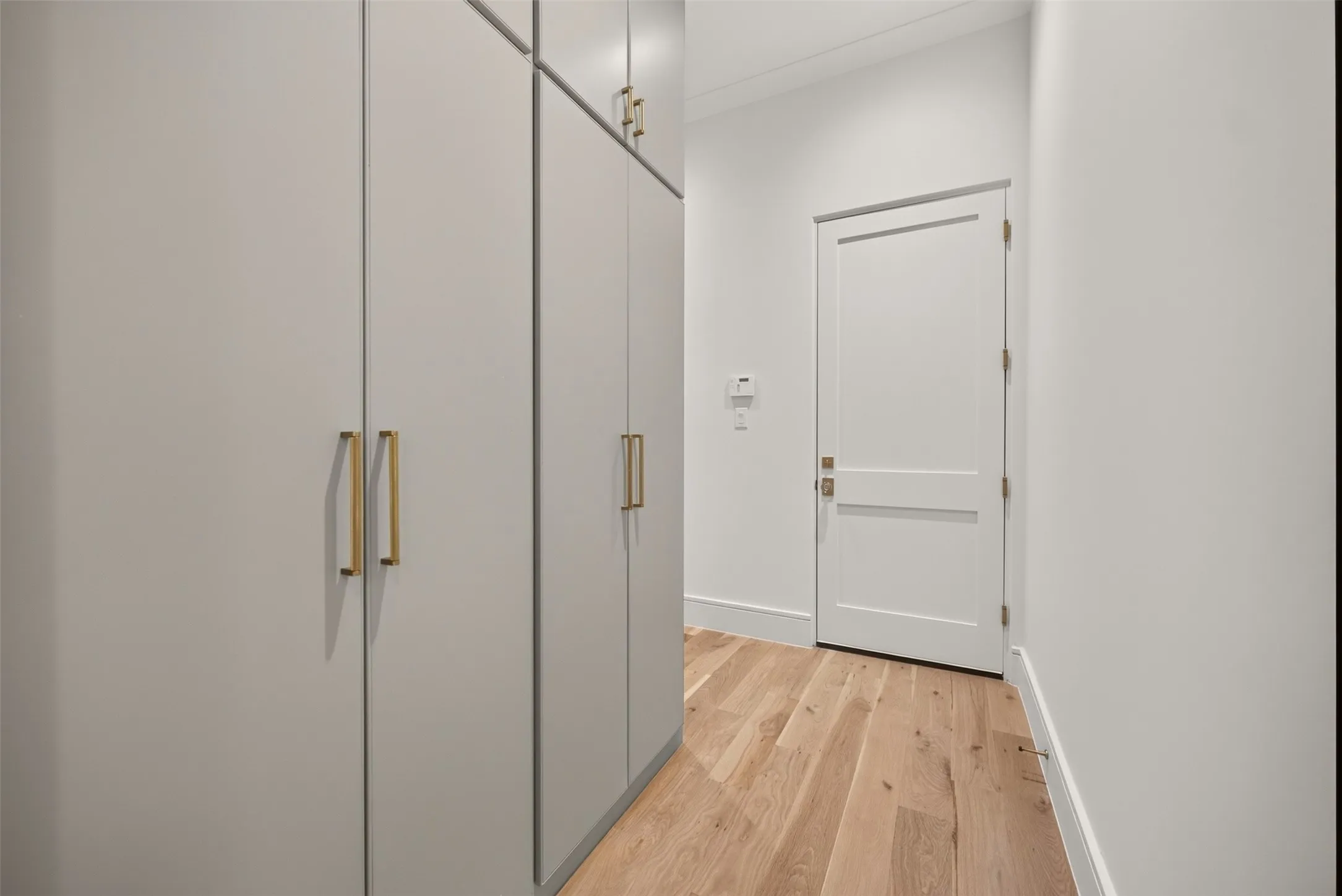 White two-panel interior door with brass hardware
